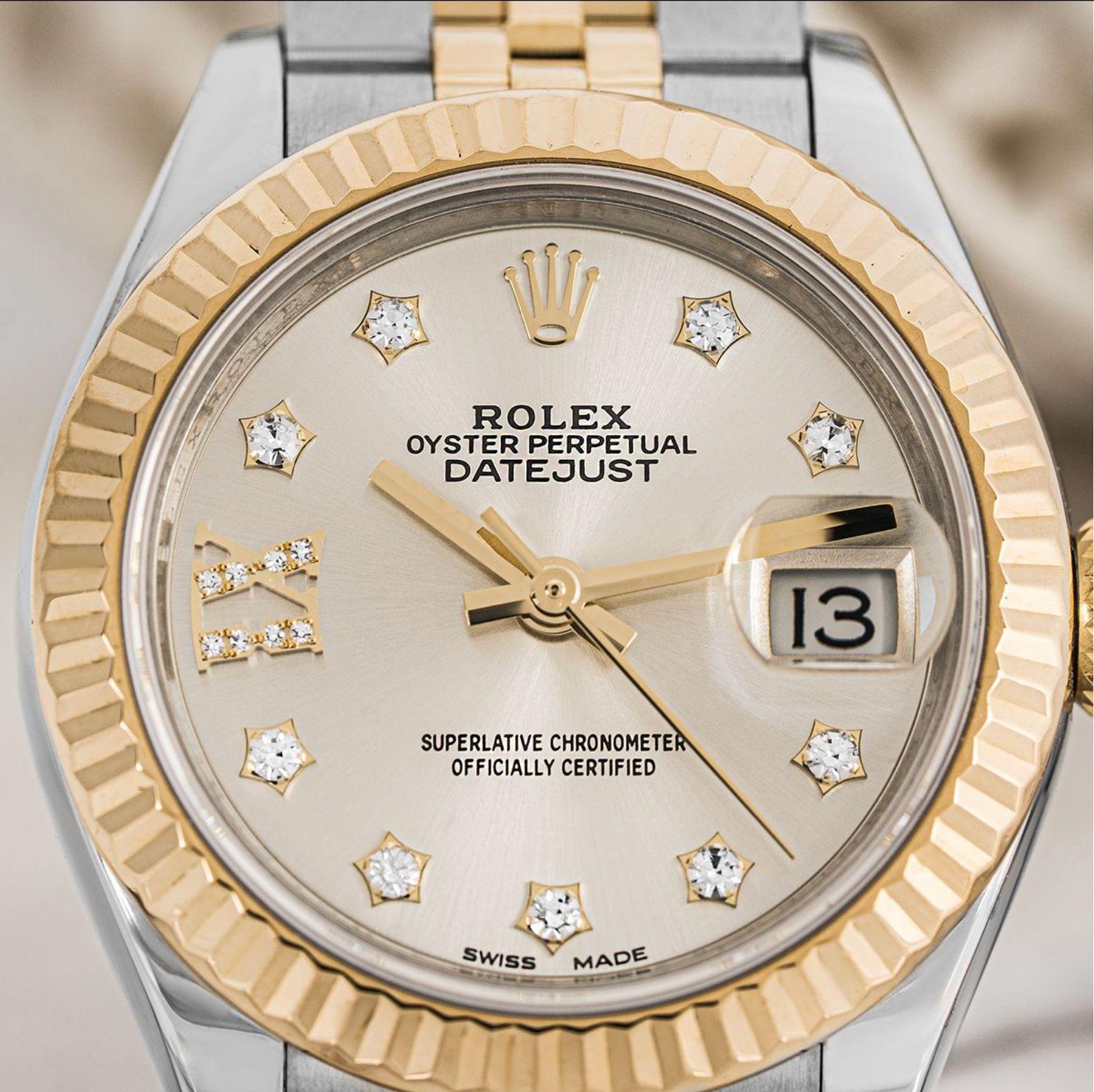A 28mm stainless steel and yellow gold Datejust by Rolex. Featuring a silver dial with diamond set hour markers and a fixed fluted yellow gold bezel. Fitted with a sapphire glass and a self-winding automatic movement. The watch is also equipped with