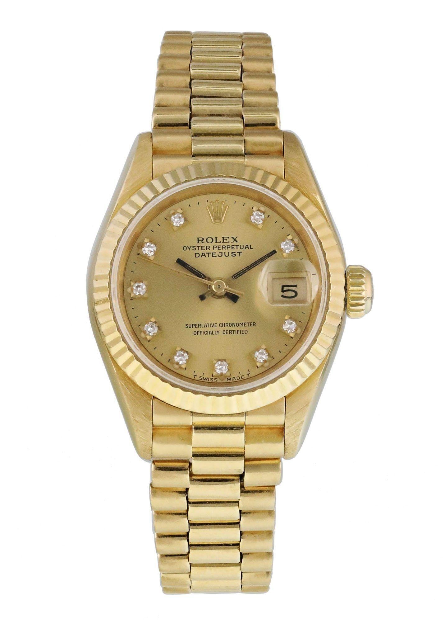 Rolex Datejust  69178 Ladies Watch. 
26mm 18k Yellow gold case. 
Yellow Gold None bezel. 
Champagne dial with luminous gold hands and factory set diamond hour markers. 
Minute markers on the outer dial. 
Date display at the 3 o'clock position.