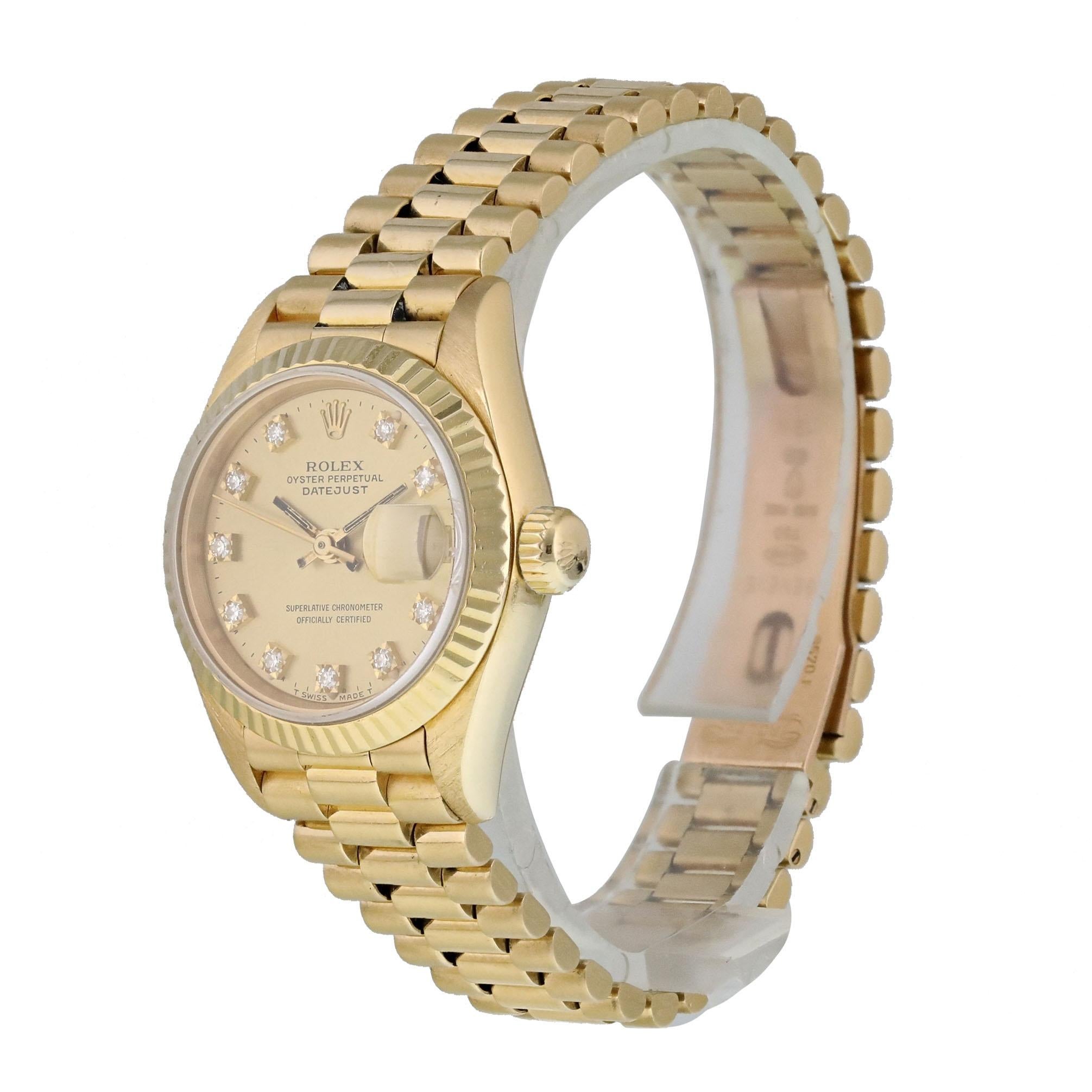 Rolex Datejust  69178 Ladies Watch. 
26mm 18k Yellow gold case. 
Yellow Gold None bezel. 
Champagne dial with luminous gold hands and factory set diamond hour markers. 
Minute markers on the outer dial. 
Date display at the 3 o'clock position.