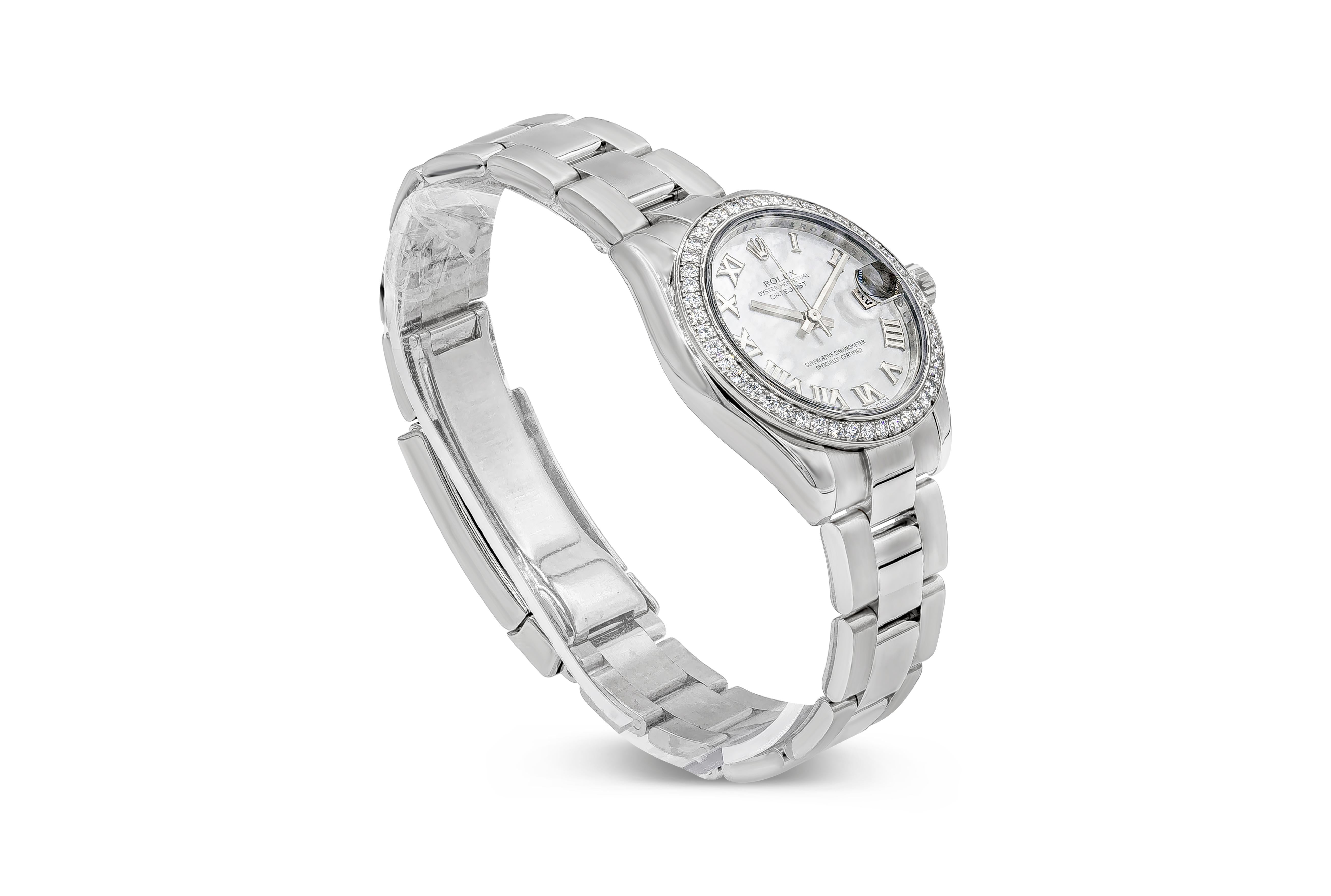 A rare and beautiful Rolex watch showcasing a mother-of-pearl dial with roman numerals. Diamond encrusted bezel. 31mm diameter. Stainless Steel. Reference no. 178384.

Accompanied by Original Box & Papers