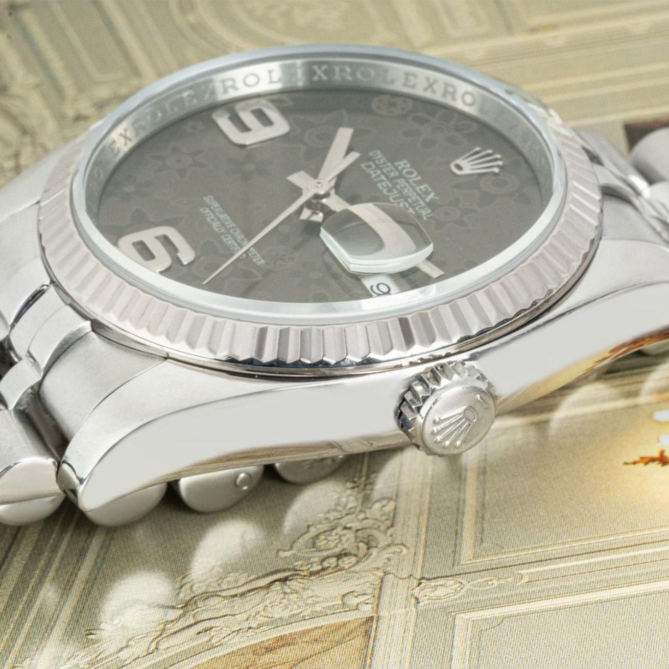 A stainless steel 36mm Datejust by Rolex. Featuring a grey floral dial and a white gold fluted bezel. The watch is fitted with a sapphire crystal, a self-winding automatic movement and a Jubilee bracelet equipped with a concealed Crown Clasp.

In