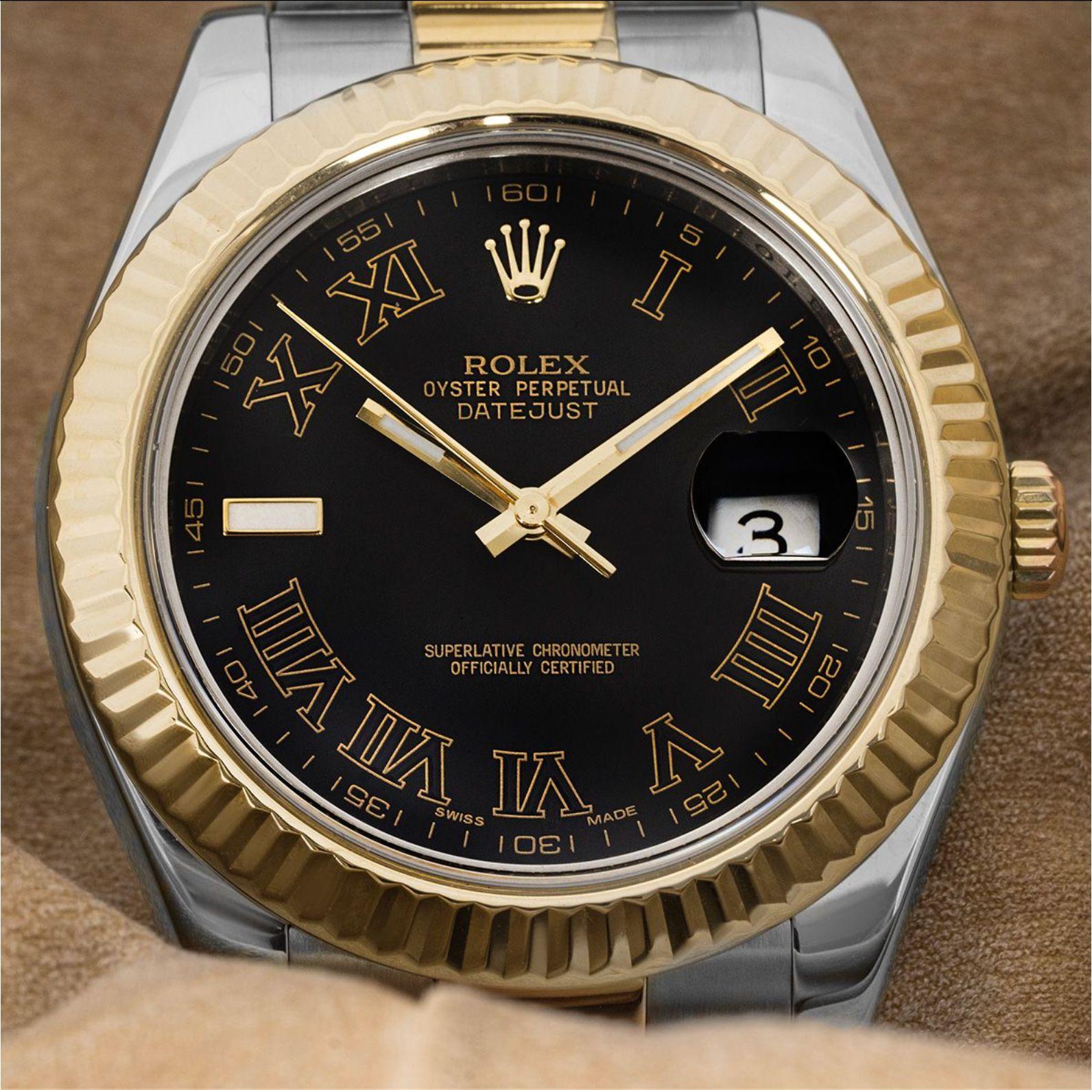 A 41mm Datejust II in steel and yellow gold by Rolex. Features a slate dial with roman numerals and a fluted yellow gold bezel. Fitted with a scratch-resistant sapphire crystal and a self-winding automatic movement. The watch is also equipped with