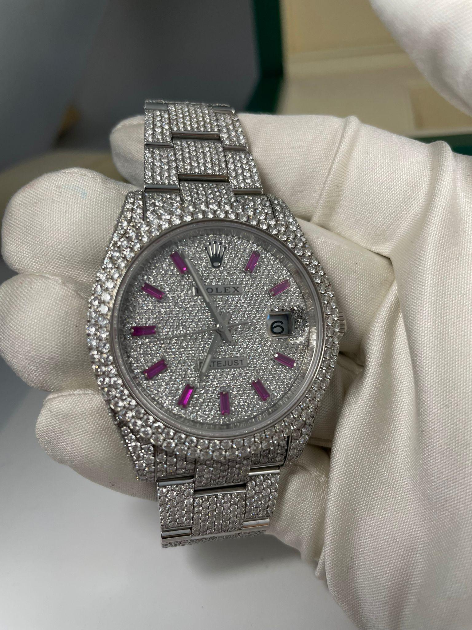 Case Shape: Round

Case Size: 41mm

Case Material: Oyster Steel

Dial: Pave Diamonds Pink Sapphire Hour Markers

Crystal: Scratch Resistant Sapphire

Bezel: Diamond

Water Resistant: 100m/330ft

Clasp: Folding Oysterlock Safety Clasp

Movement: