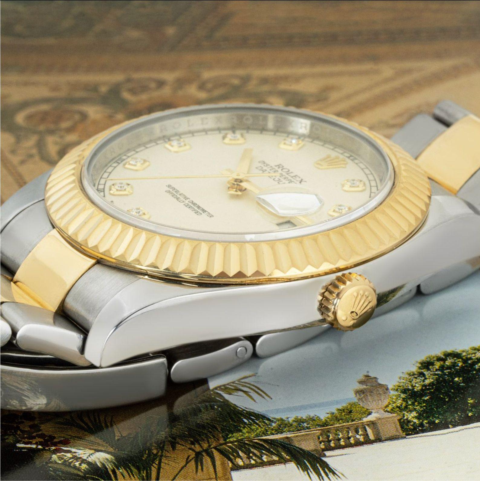 A 41mm Datejust II in Oystersteel and yellow gold by Rolex. Featuring a silver dial with diamond hour marks and a fluted yellow gold bezel. Fitted with scratch-resistant sapphire crystal and a self-winding automatic movement. The Oyster bracelet