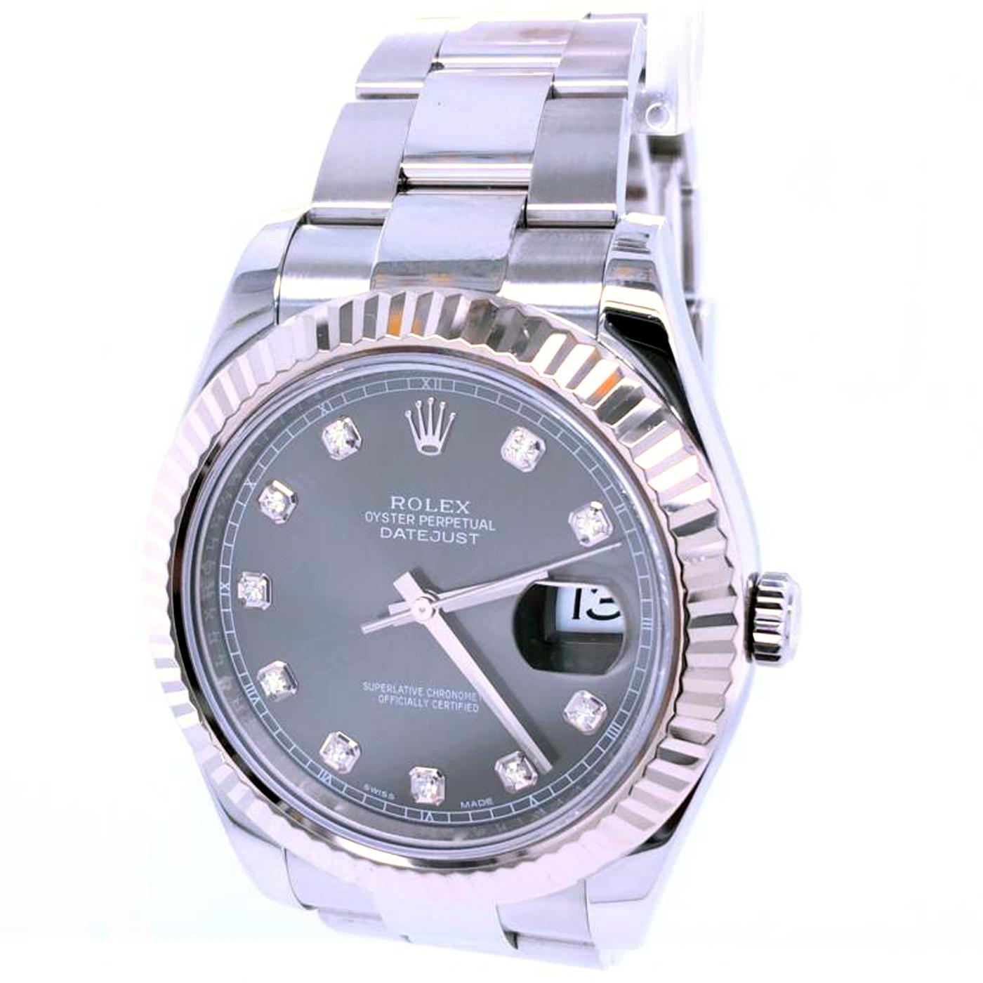 This Rolex Datejust II 41mm has diamond hour markers. Minute markers around the outer rim. Dial Type: Analog. The date display appears at the 3 o'clock position. Automatic movement. Scratch-resistant sapphire crystal. Screw down the crown. Solid
