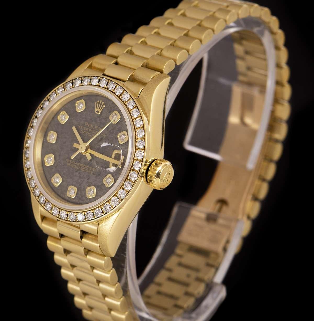 A 1994 18k Yellow Gold Oyster Perpetual Datejust Ladies Wristwatch, rare ammonite dial set with 10 applied round brilliant cut diamond hour markers, date at 3 0'clock, a fixed 18k yellow gold bezel set with approximately 40 round brilliant cut
