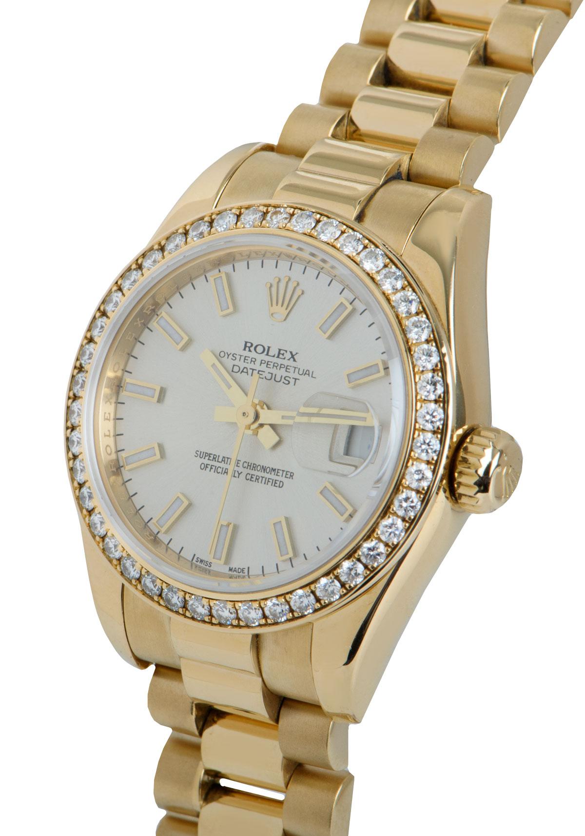 An 18k Yellow Gold Oyster Perpetual Datejust Ladies Wristwatch, silver dial with applied hour markers, date at 3 0'clock, a fixed 18k yellow gold bezel set with 42 round brilliant cut diamonds, an 18k yellow gold president bracelet with a concealed