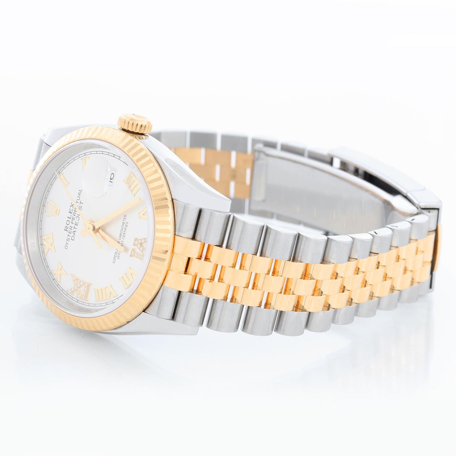 Rolex Datejust Men's 2-Tone 126233 Watch - Automatic winding, 31 jewels, Quickset, sapphire crystal. Stainless steel case with 18k yellow gold fluted bezel ( 36 mm ) . Silver dial with diamond 6 and 9 o'clock. Stainless steel and 18k yellow gold