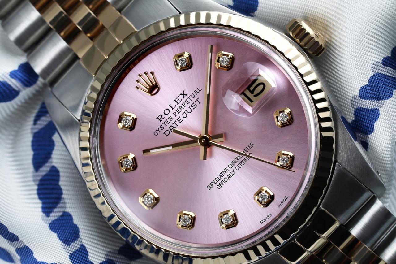 Rolex 36mm Datejust Metallic Pink Diamond Dial 18k Yellow Gold & Stainless Steel Watch 16013.
This watch is in like new condition. It has been polished, serviced and has no visible scratches or blemishes. All our watches come with a standard 1 year