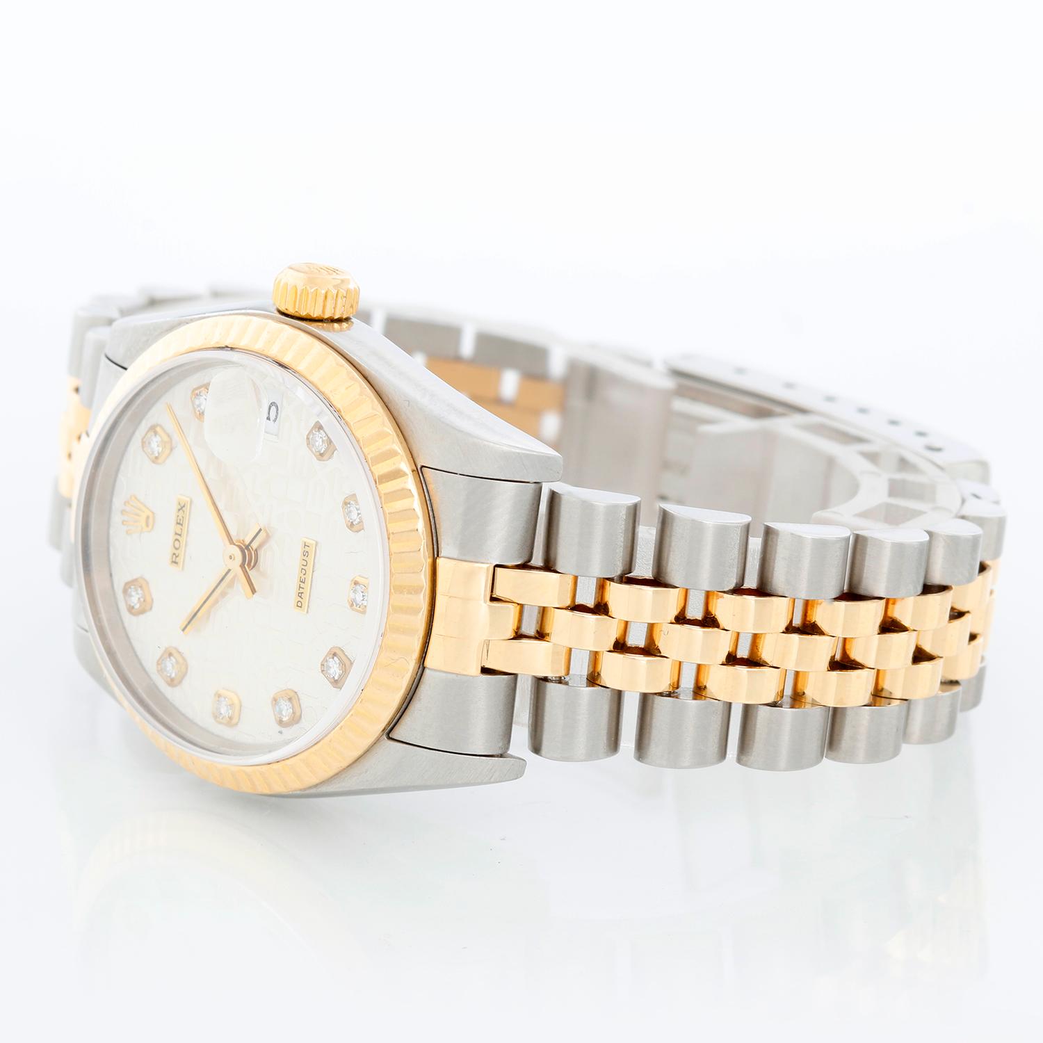 Rolex Datejust Midsize 2-Tone Men's or Ladies Watch 78273 - Automatic winding, 31 jewels, Quickset, sapphire crystal.  Stainless steel case with yellow gold fluted bezel. Silver Jubilee diamond dial. Stainless steel and 18k yellow gold Jubilee