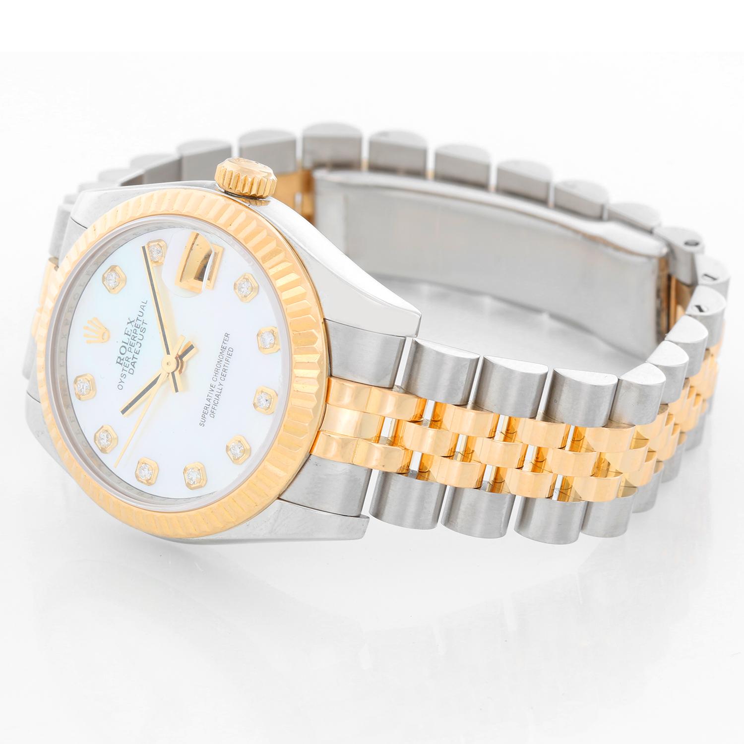 Rolex Datejust Midsize 2-Tone Watch 178273 - Automatic winding; 31 jewel; sapphire crystal. Stainless steel case with yellow gold fluted bezel.. Custom Mother of Pearl . Stainless steel hidden-clasp Jubilee bracelet. Pre-owned with Rolex box and