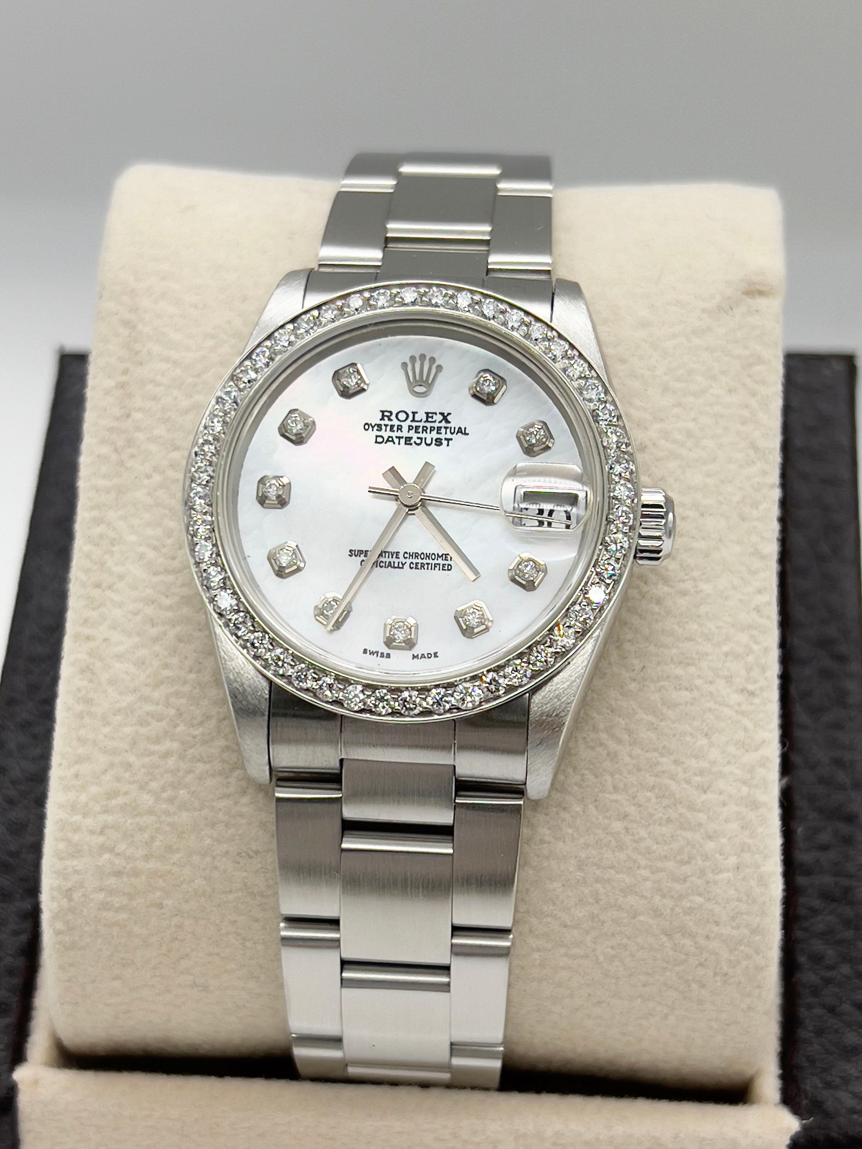 Style Number: 78240
Serial: Y882***
Year: 2002
Model: Rolex Datejust Midsize
Case Material: Stainless Steel
Band: Stainless Steel
Bezel: Custom Diamond Bezel
Dial: Custom Mother of Pearl Diamond Dial
Face: Sapphire Crystal
Case Size: 31mm
Includes: