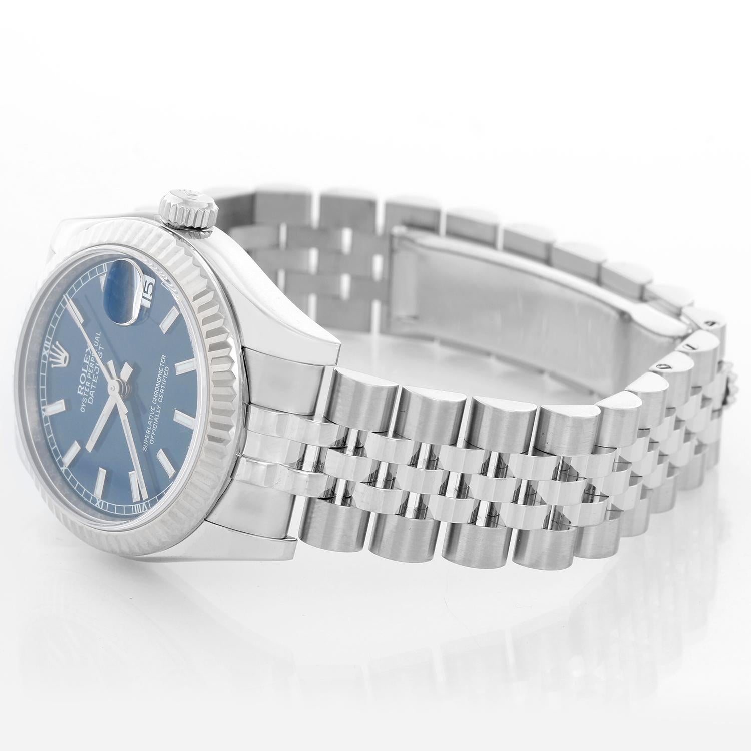 Rolex Datejust Midsize Men's or Ladies Steel Watch 178274 - Automatic winding; 31 jewel; sapphire crystal. Stainless steel case with 18k white gold fluted bezel (31mm diameter). Blue dial with stick hour markers . Stainless steel hidden-clasp