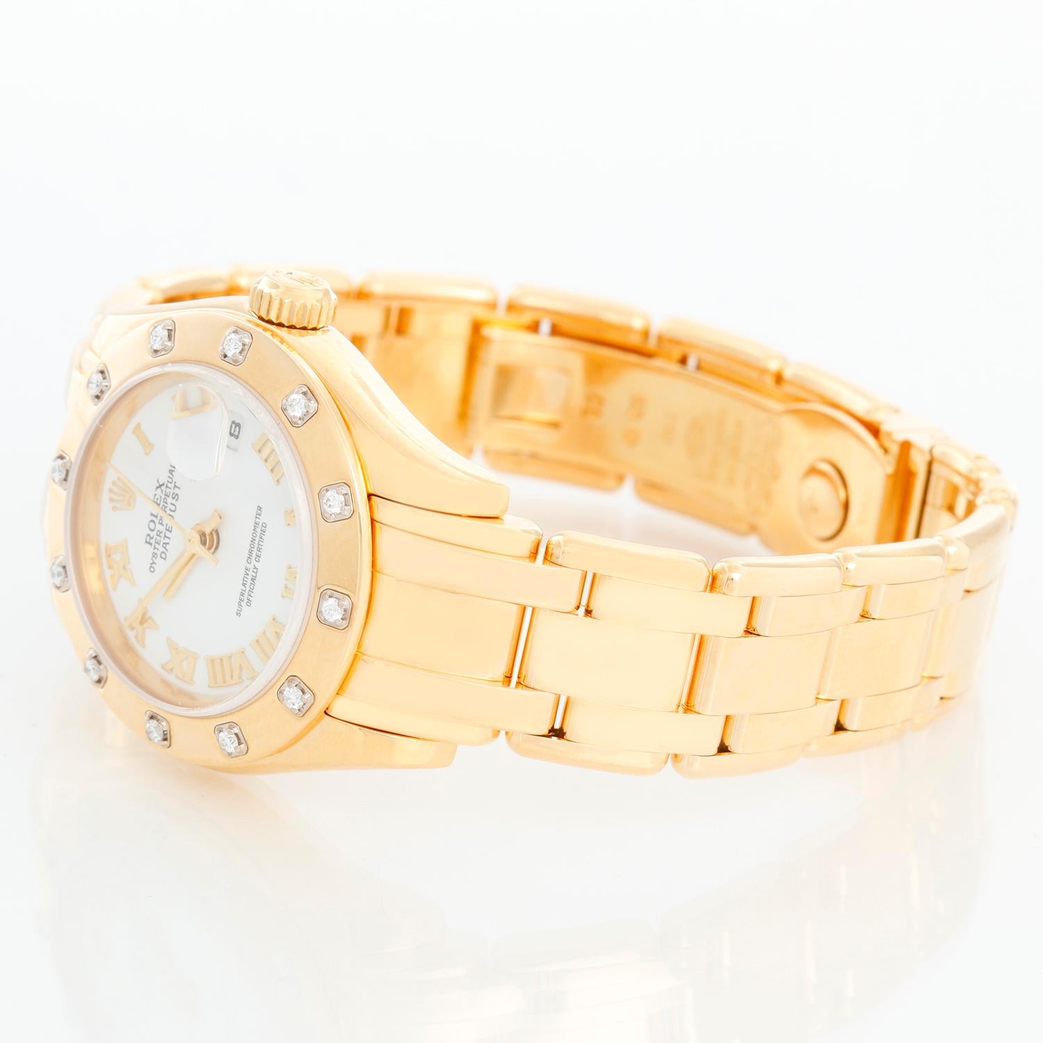 Rolex Lady Datejust Pearlmaster 18k Yellow Gold Ladies Diamond Watch 80318 - Automatic winding, 31 jewels, Quickset, sapphire crystal. 18k yellow gold case with factory 12 diamond bezel (29mm diameter). White Roman numerals Dial. 18k yellow gold