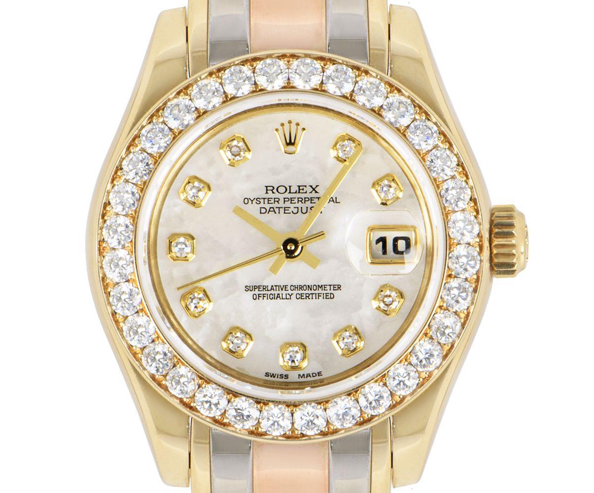 A stunning ladies Datejust Pearlmaster crafted in tri-gold by Rolex. Featuring a mother of pearl dial with diamond set applied hour markers and a date aperture at 3 o'clock. Complementing the dial is a fixed yellow gold bezel set with 32 brilliant