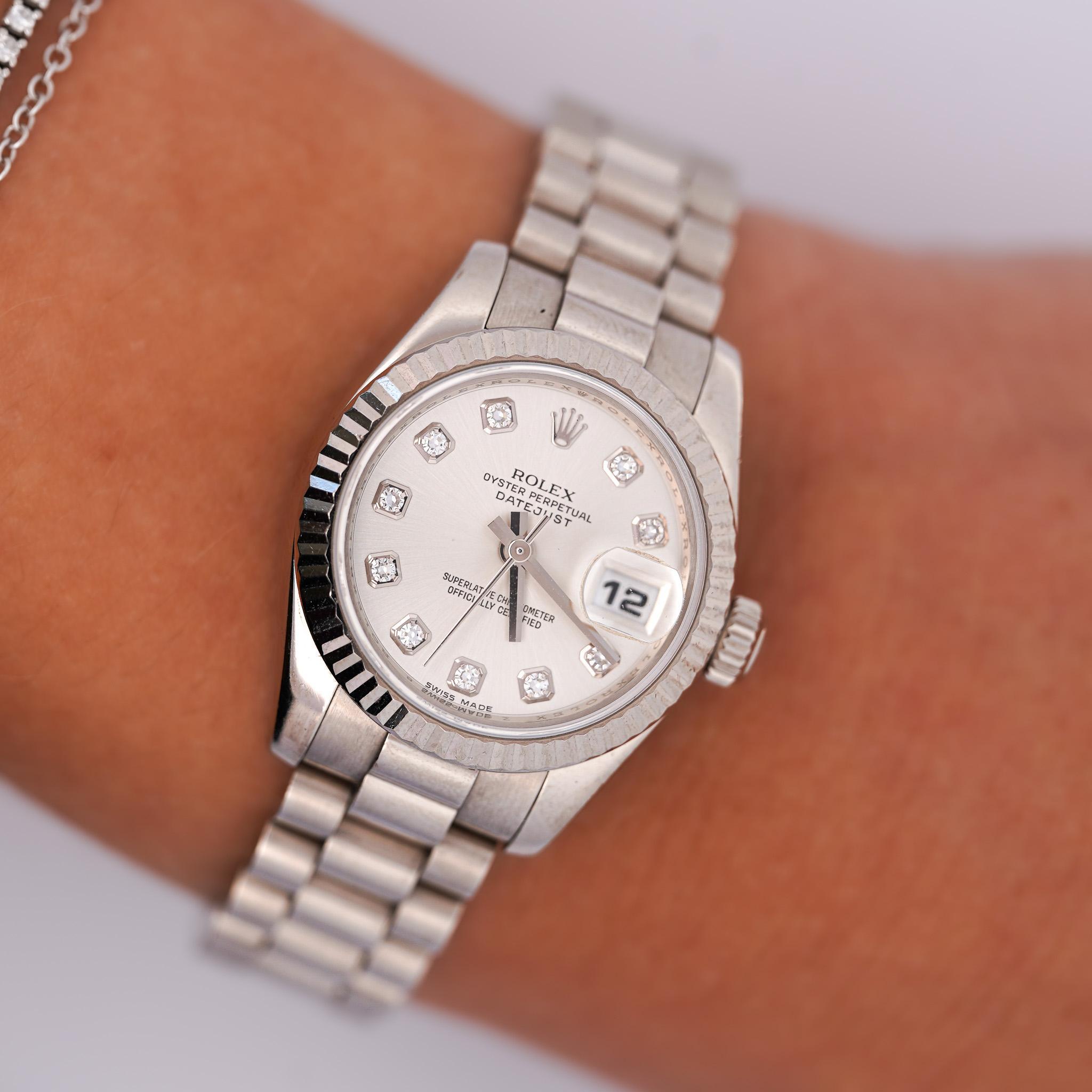 18K White Gold Ladies Rolex DateJust President With Factory Round Diamond Hour Markers With Original Rolex Box And Card. 

Brand: Rolex
Model Name: Rolex President DateJust Ladies 18K White Gold Watch 179179
Model Number: 179179
Year: 2003
Serial