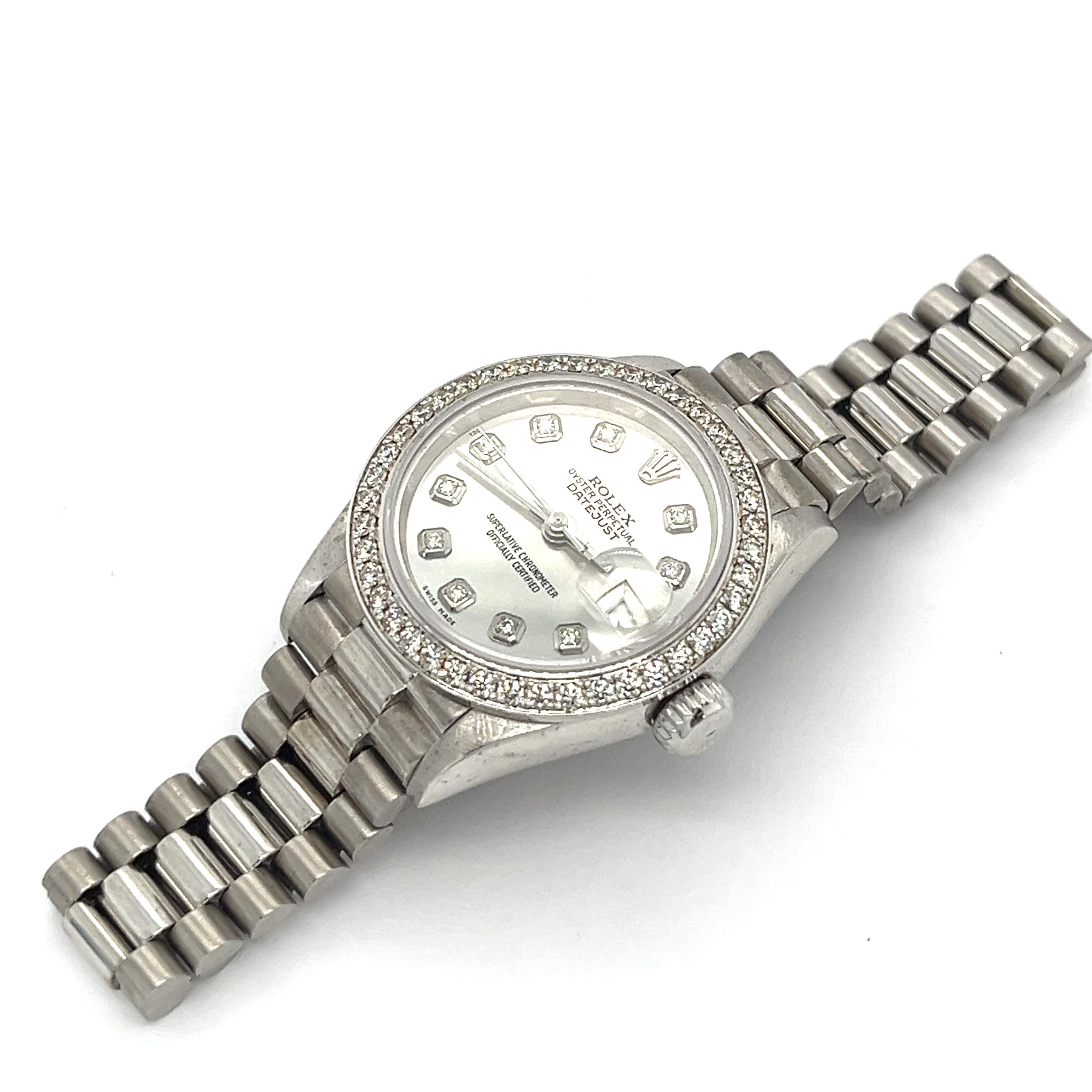Women's Pre-owned 26mm Rolex Datejust President in 18K white gold. Embellished with 10 round  diamond dial markers and a shimmering silver dial, this Datejust President watch is a keepsake to last generations. Complete with a bead set bezel
