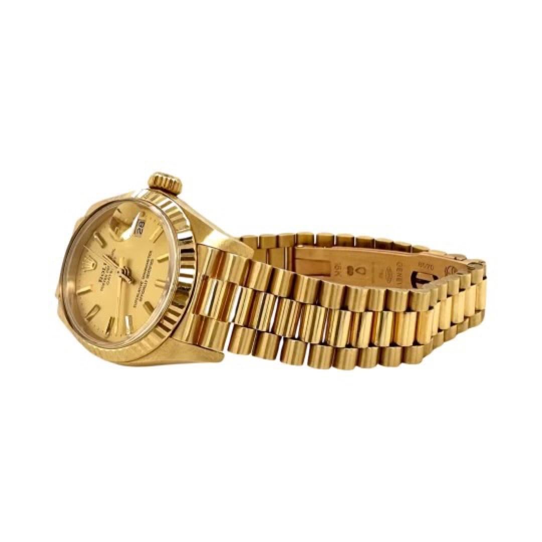 Brand: Rolex 

Model Name: Datejust 26

Model Number: 6917

Movement: Mechanical Automatic

Case Size: 26 mm

Case Material: 18k Yellow Gold

Bracelet: Presidential

Dial: Champagne

Bezel: 18k Yellow Gold

Year:  Unknown

Includes:  24 Months