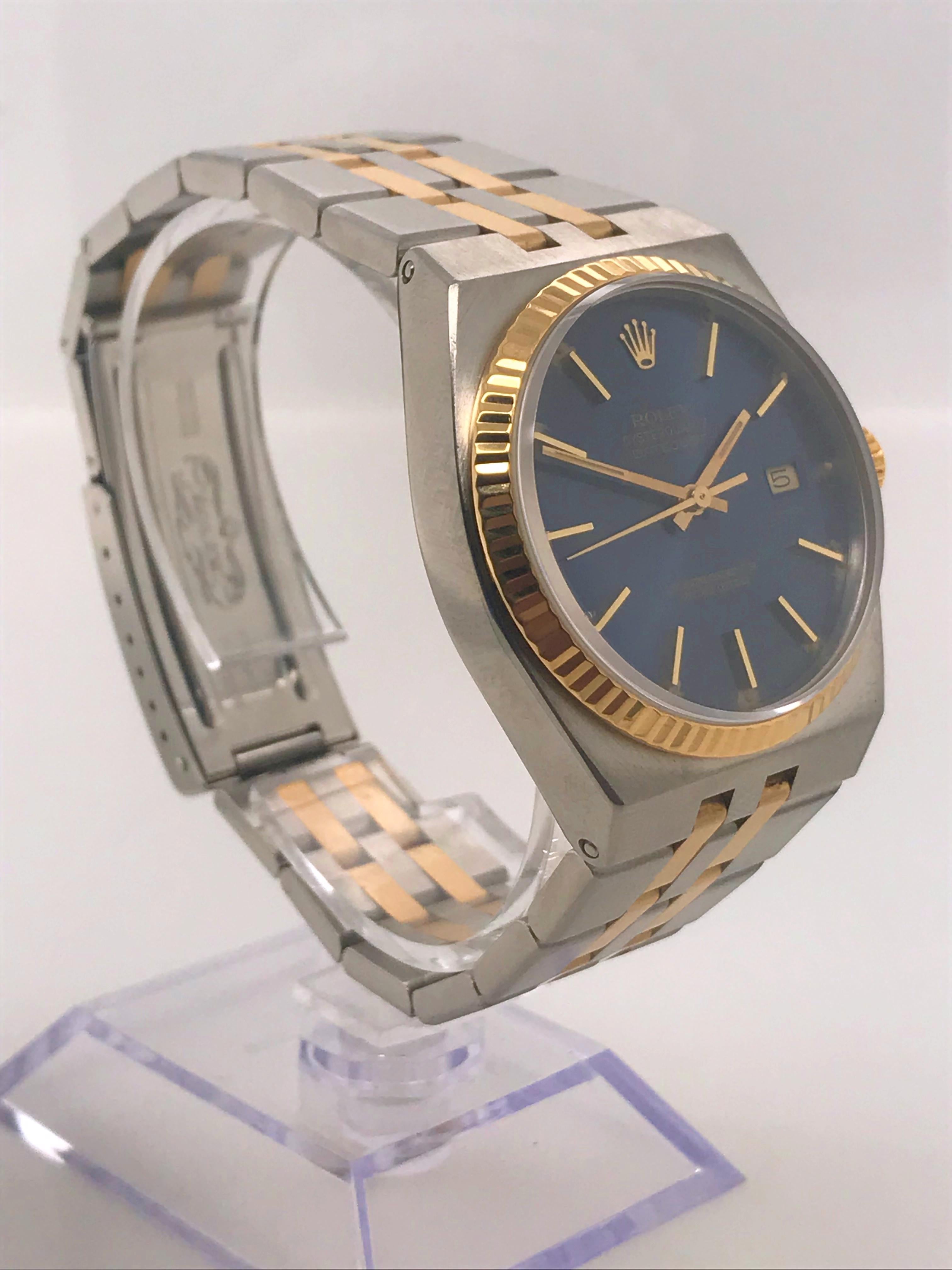 This two-tone Rolex Datejust is rare due to its quartz movement. This watch is crafted from stainless steel and 18 karat yellow gold. It features a blue dial with gold markers and a date function at the 6 o’clock position. 

This timepiece was