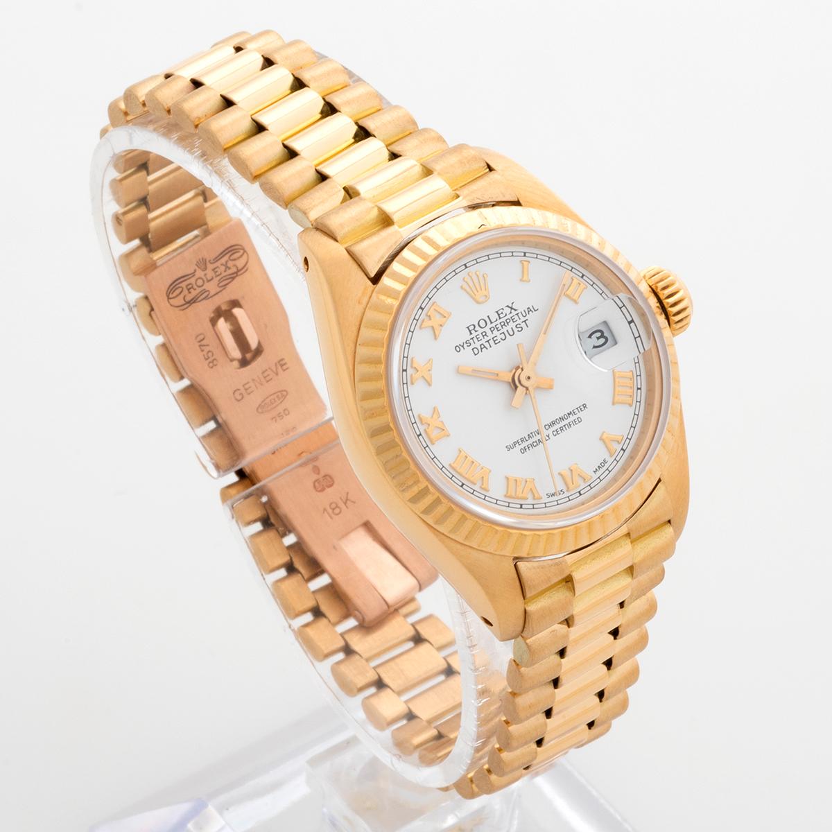 Our ladies Rolex Datejust, reference 6917 / 8 features an 18k yellow gold case and 18k yellow gold president style bracelet. This example is presented in very good condition, with a strong case, service white Roman numeral dial, and some stretch to