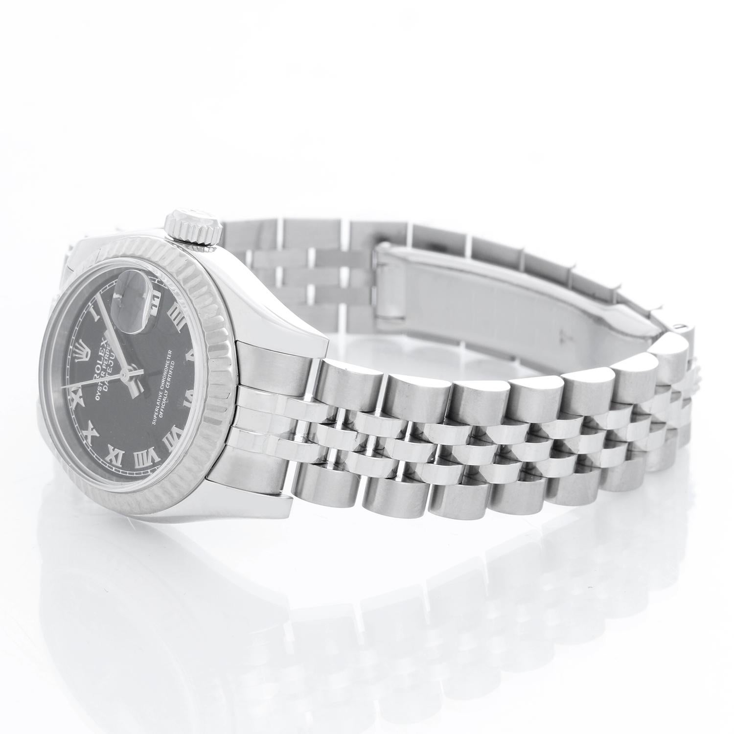 Rolex  Datejust Stainless Steel & White Gold  Ladies Watch 179174 - Automatic winding; 31 jewel; sapphire crystal. Stainless steel case with 18k white gold fluted bezel ( 26 mm) . Black dial with Roman numerals. Stainless steel hidden-clasp Jubilee