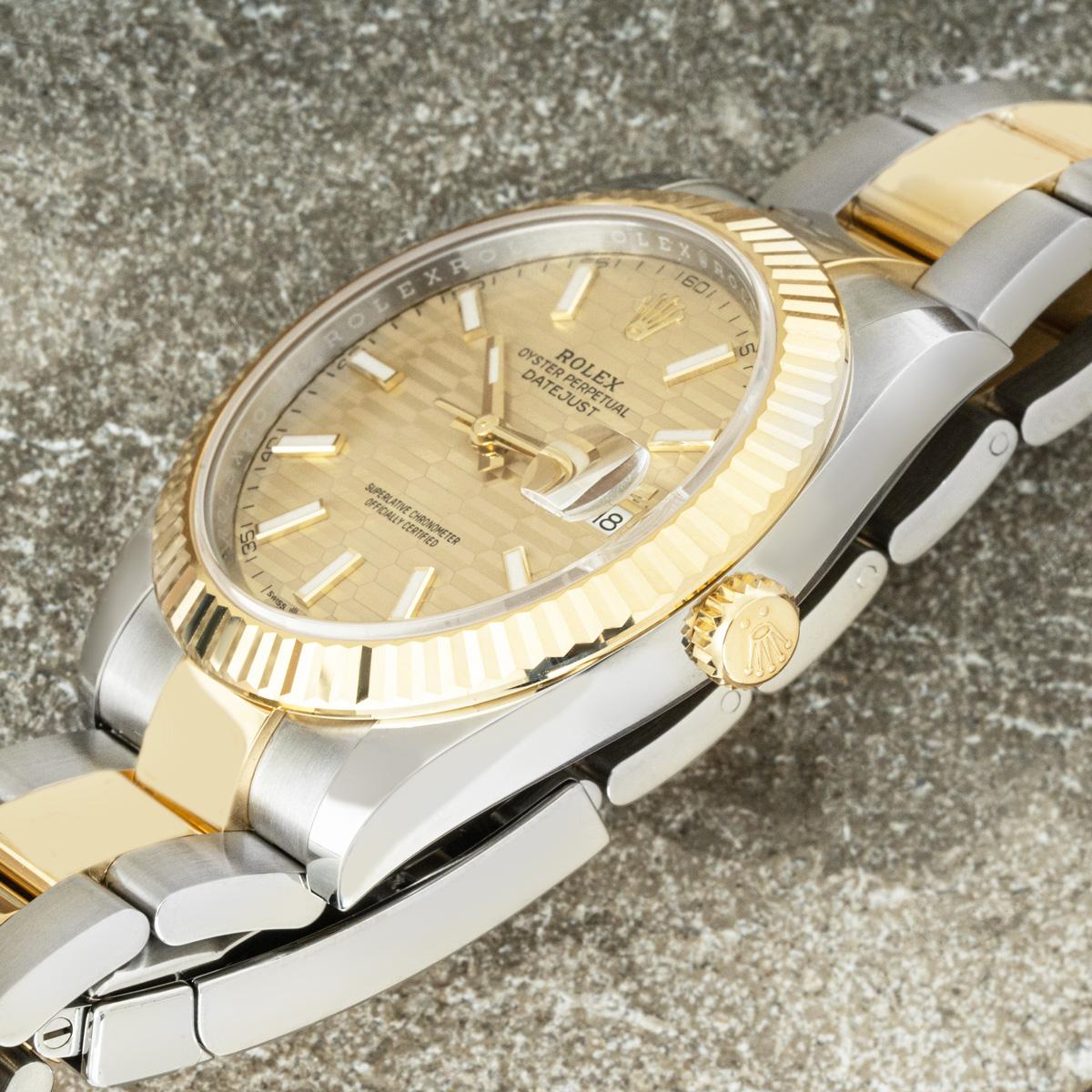 A steel and gold men's Datejust 41mm by Rolex. Featuring a champagne fluted motif dial with a yellow gold fluted bezel. Fitted with a sapphire crystal and a self-winding automatic movement. The watch is also equipped with a steel and gold Oyster