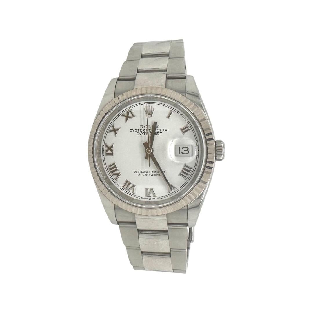 Brand: Rolex

Model Name: Datejust 

Model Number: 126234

Movement: Mechanical Automatic

Case Size: 36 mm

Case Material: Stainless Steel

Dial: White

Bracelet: Oyster

Bezel: White Gold Fluted 

Crystal: Sapphire Crystal 

Year:  2019

Water