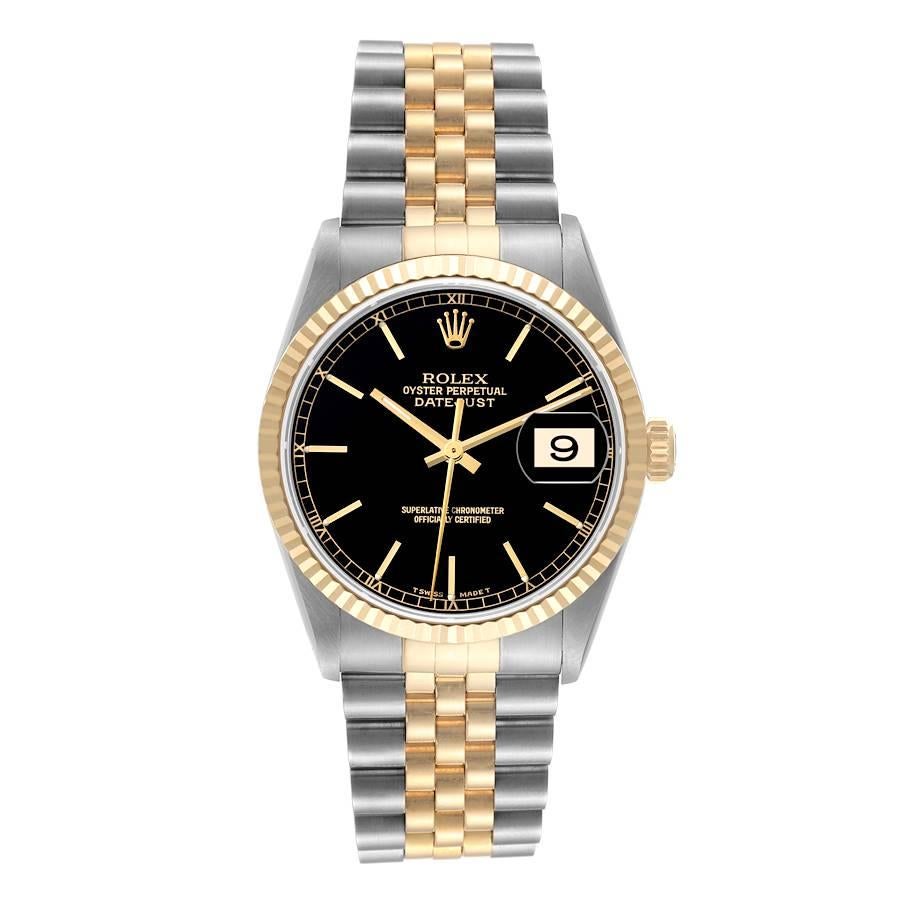 Rolex Datejust Steel Yellow Gold Black Dial Mens Watch 16233 Box Service Card. Officially certified chronometer automatic self-winding movement. Stainless steel case 36 mm in diameter.  Rolex logo on an 18K yellow gold crown. 18k yellow gold fluted