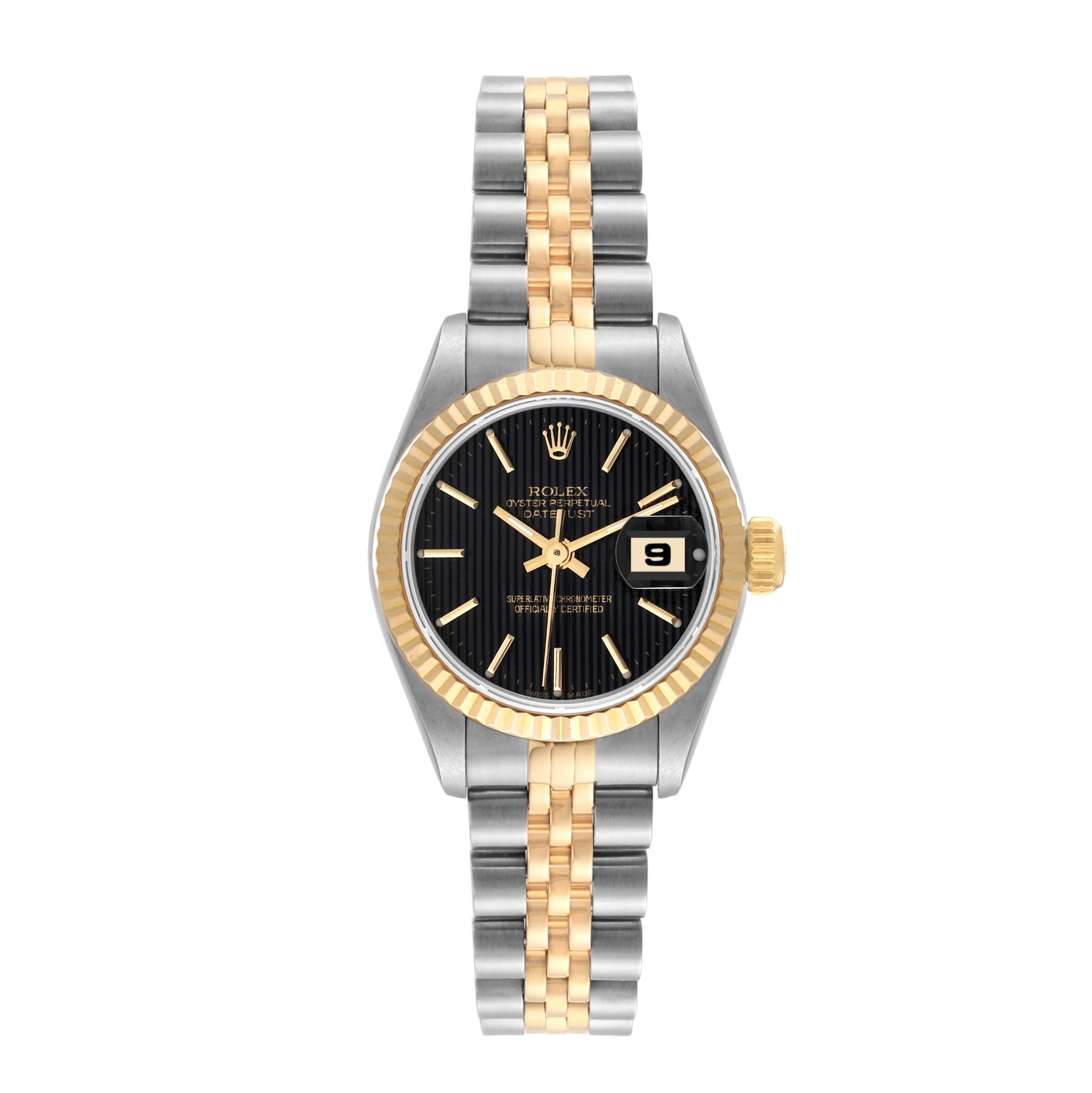 Rolex Datejust Steel Yellow Gold Black Tapestry Dial Ladies Watch 69173. Officially certified chronometer automatic self-winding movement. Stainless steel oyster case 26.0 mm in diameter. Rolex logo on the crown. 18k yellow gold fluted bezel.