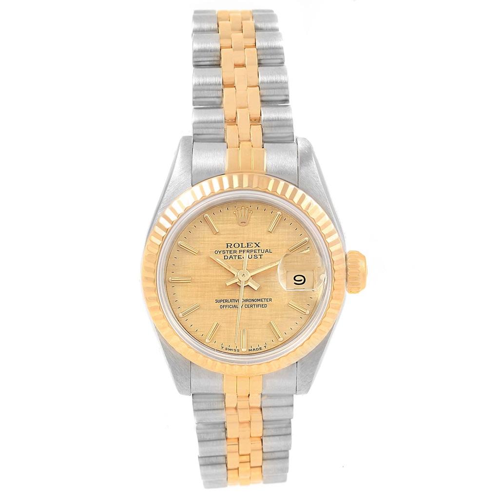 Rolex Datejust Steel Yellow Gold Champagne Linen Dial Ladies Watch 69173. Officially certified chronometer self-winding movement. Stainless steel oyster case 26.0 mm in diameter. Rolex logo on a crown. 18k yellow gold fluted bezel. Scratch resistant