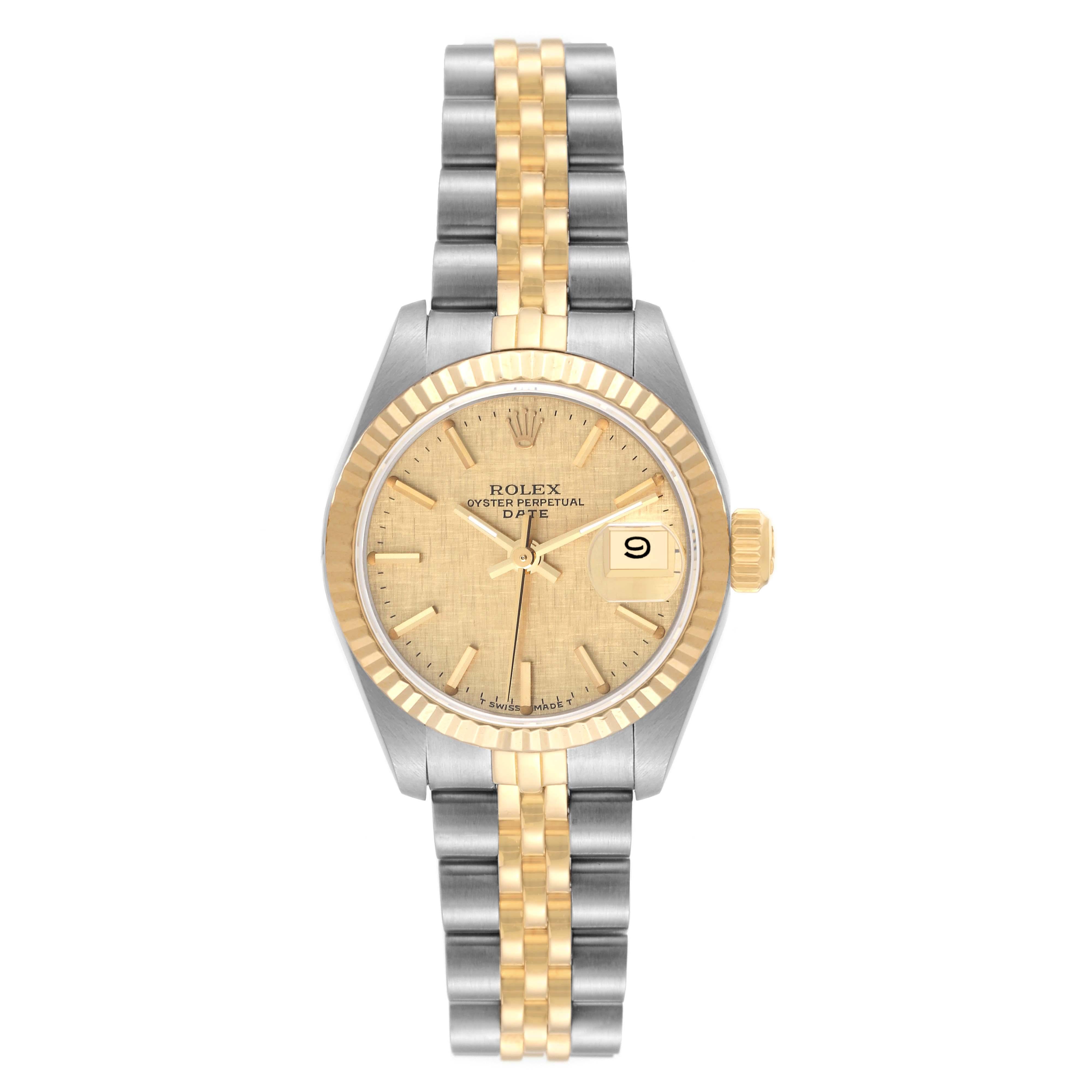 Rolex Datejust Steel Yellow Gold Champagne Linen Dial Ladies Watch 69173. Officially certified chronometer automatic self-winding movement. Stainless steel oyster case 26.0 mm in diameter. Rolex logo on the crown. 18k yellow gold fluted bezel.