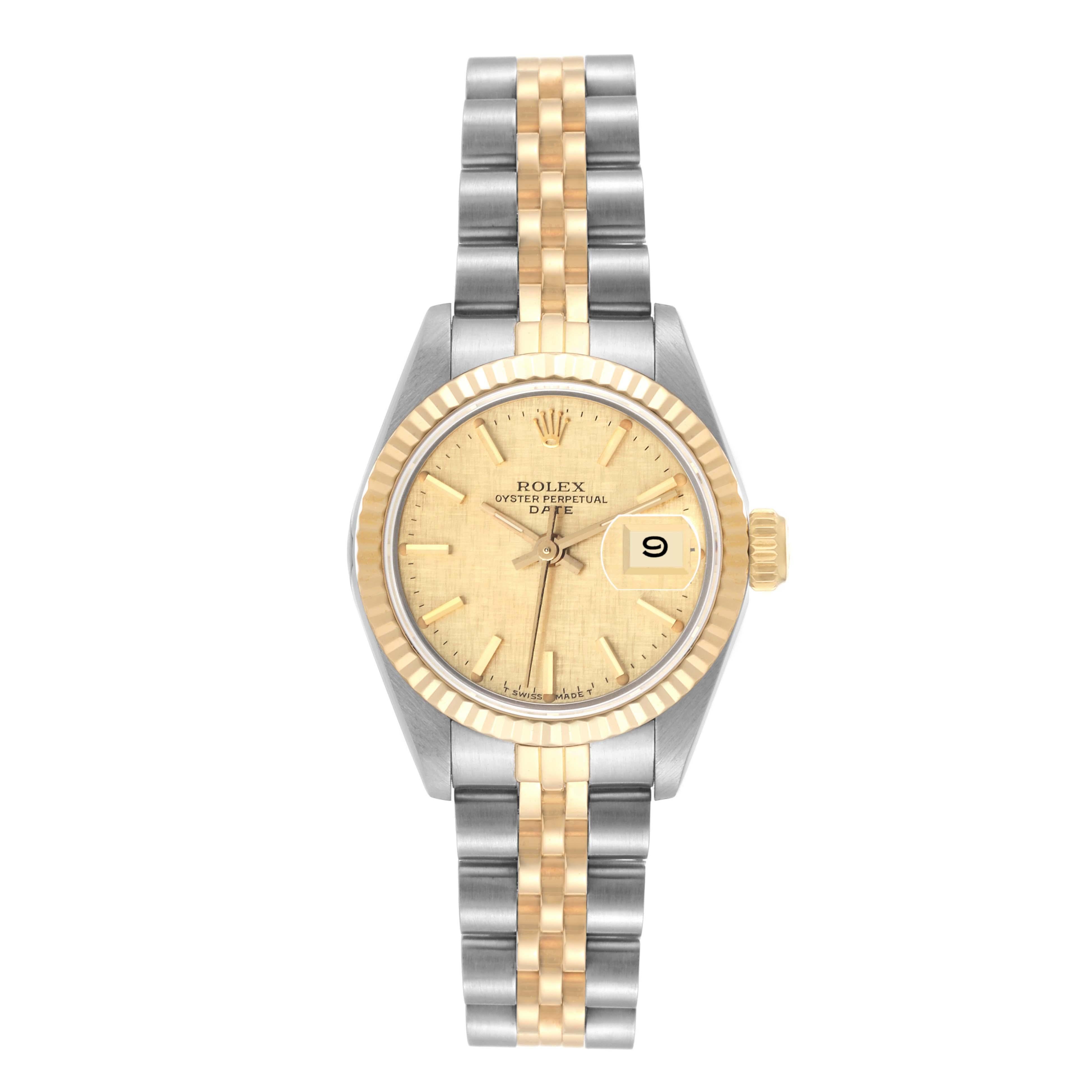 Rolex Datejust Steel Yellow Gold Champagne Linen Dial Ladies Watch 69173. Officially certified chronometer automatic self-winding movement. Stainless steel oyster case 26.0 mm in diameter. Rolex logo on the crown. 18k yellow gold fluted bezel.
