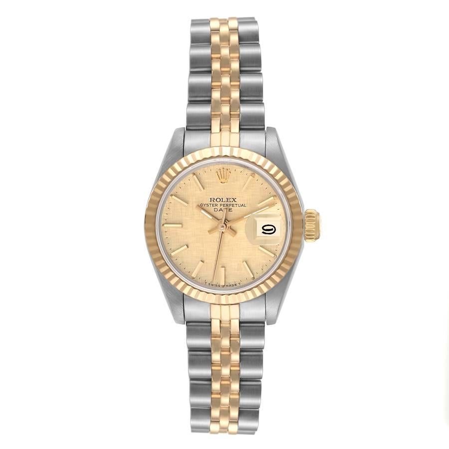 Rolex Datejust Steel Yellow Gold Linen Dial Ladies Watch 69173. Officially certified chronometer automatic self-winding movement. Stainless steel oyster case 26.0 mm in diameter. Rolex logo on the crown. 18k yellow gold fluted bezel. Scratch