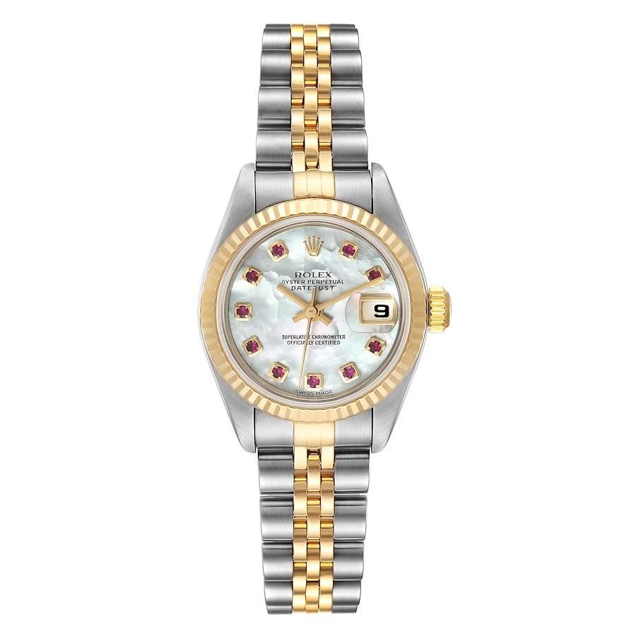 Rolex Datejust Steel Yellow Gold MOP Ruby Dial Ladies Watch 79173. Officially certified chronometer self-winding movement. Stainless steel oyster case 26 mm in diameter. Rolex logo on a 18K yellow gold crown. 18k yellow gold fluted bezel. Scratch