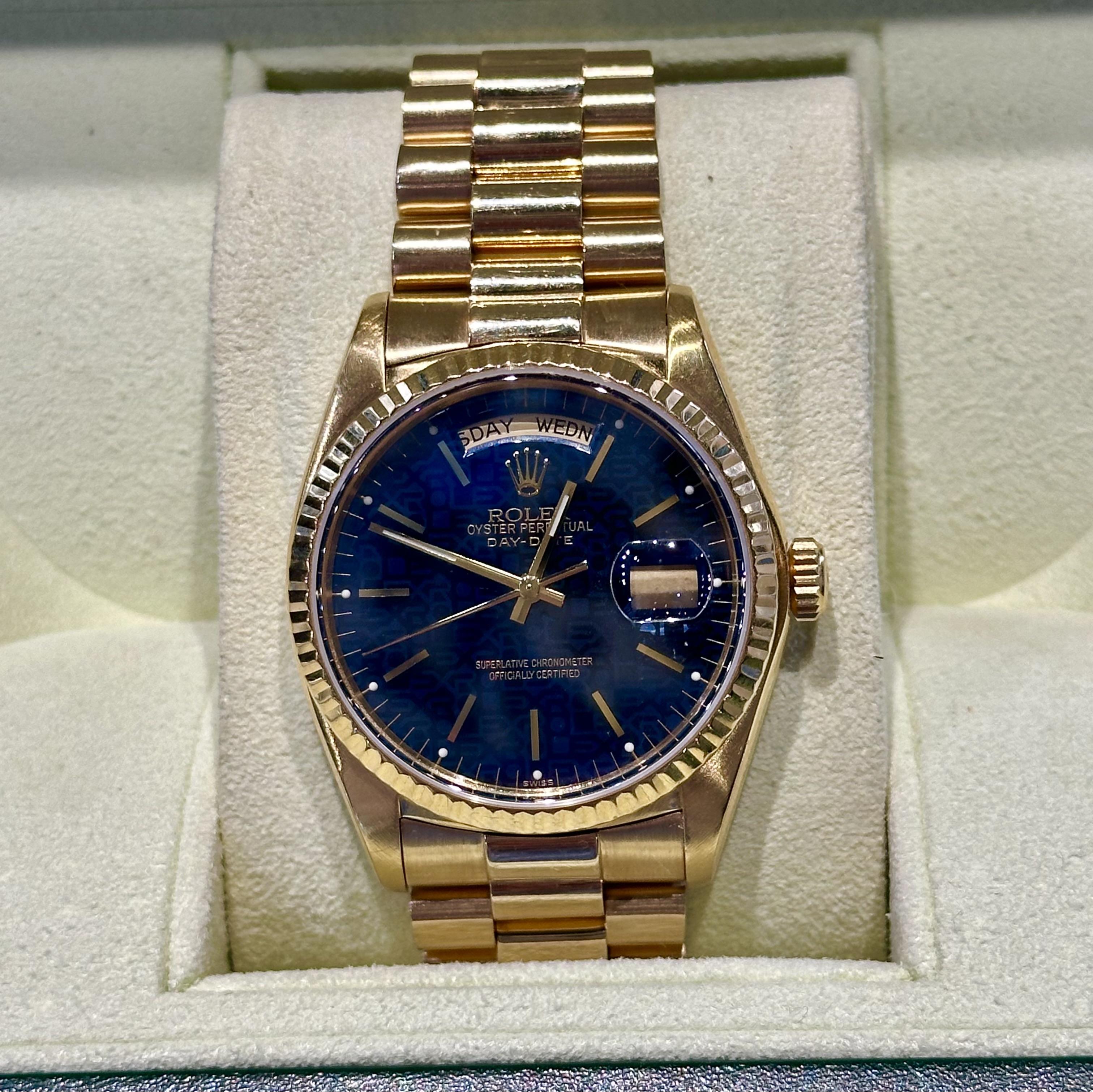 Brand: Rolex 
Model Name: Day-Date 
Model Number: 18038
Year: 1980
Movement: Automatic
Case Size: 36 mm
Case Material: 18k Yellow Gold
Bezel: 18k Yellow Gold 
Dial: Blue Rolex Celebration Dial
Bracelet: Aftermarket bracelet
Features: Hours, Minutes,