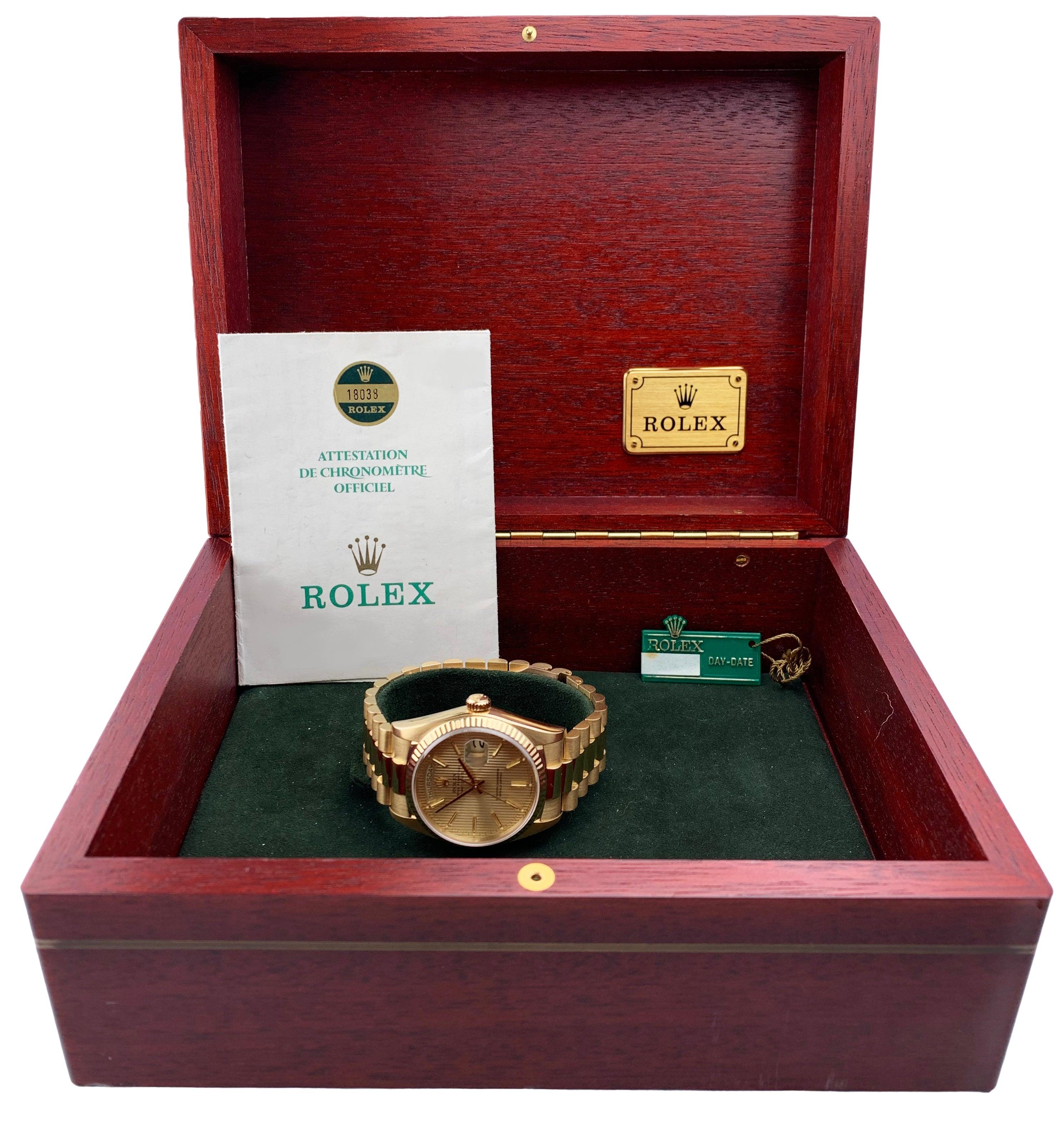 
Rolex Day-Date 18038 Men's Watch. 36mm 18k Yellow gold case with 18k yellow gold fluted bezel. Champagne tapestry dial with gold hands and index hour markers. Date display at the 3 o'clock position. Day display at the 12 o'clock position. 18k