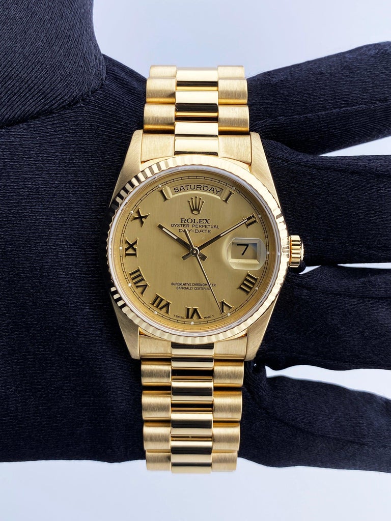 Rolex Day Date 18238 Mens Watch. 36mm 18K yellow gold case with 18K yellow gold fluted bezel. Champagne dial with gold hands and Roman numeral hour marker. Date display at 3 o'clock position and day display at 12 o'clock position. 18K yellow gold