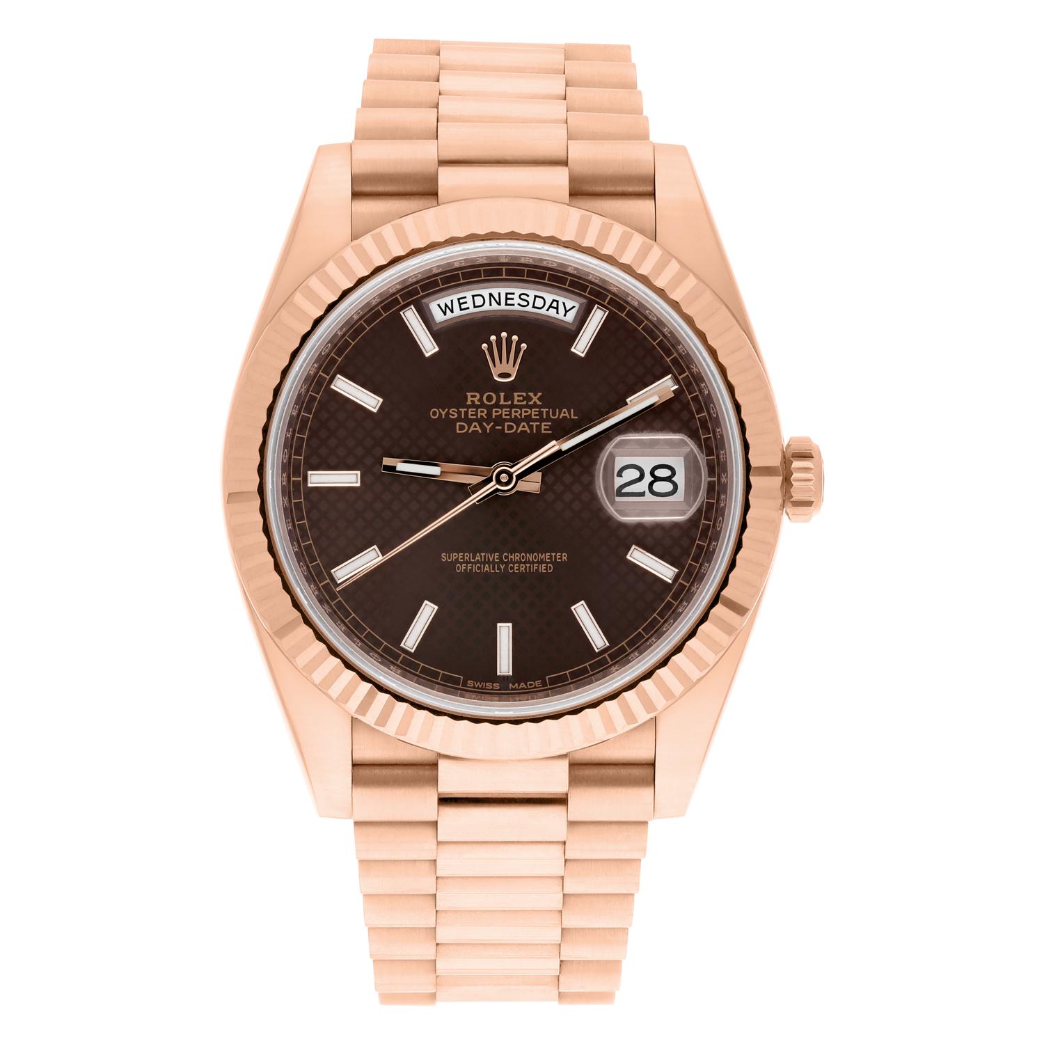 This Rolex Day-Date wristwatch features a stunning 40mm rose gold case and a unique chocolate motif dial with honeycomb pattern and stick indexes. The President band/strap complements the luxurious and classic style of this watch. This mechanical