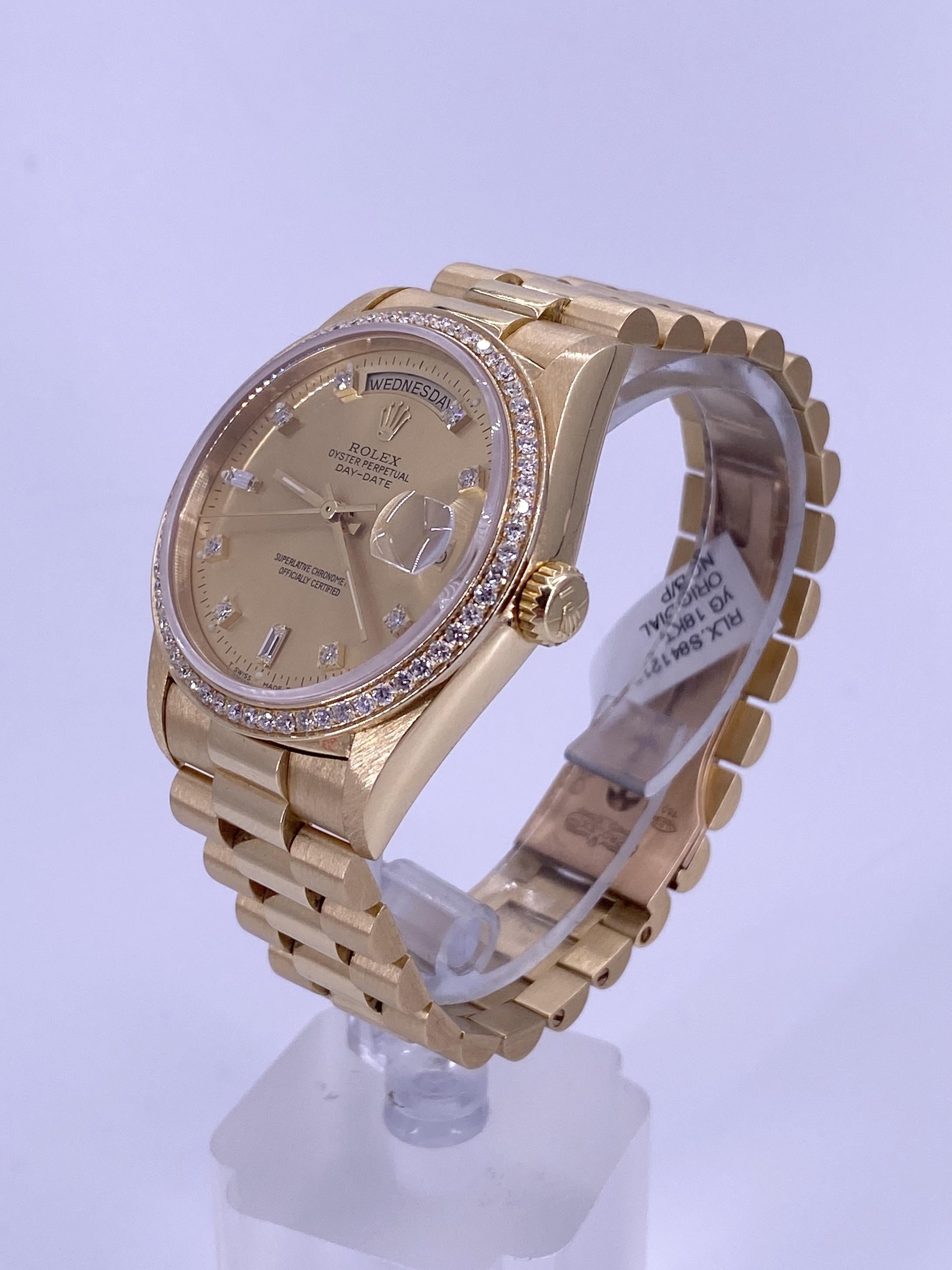 BRAND: Rolex
MODEL: Day-Date 36
REFRENCE: 18238
SIZE: 36mm
CASE: 18k Yellow Gold
DIAL: Champagne with Diamonds (Original)
BEZEL: Diamonds (Custom)
BAND: President 18k Yellow Gold
MOVEMENT: Automatic

Original Diamond Dial
Custom Diamond Bezel
Very