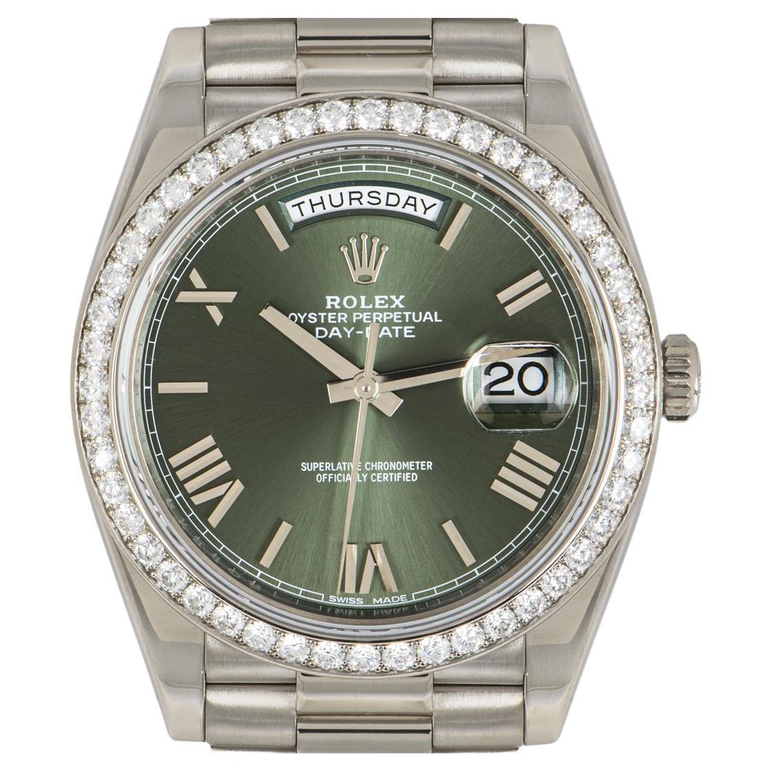 A men's white gold Day-Date 40 by Rolex. Featuring the highly sought after olive green dial with Roman numerals and bezel set with 48 round brilliant cut diamonds. The president bracelet and concealed folding Crownclasp are signature Day-Date
