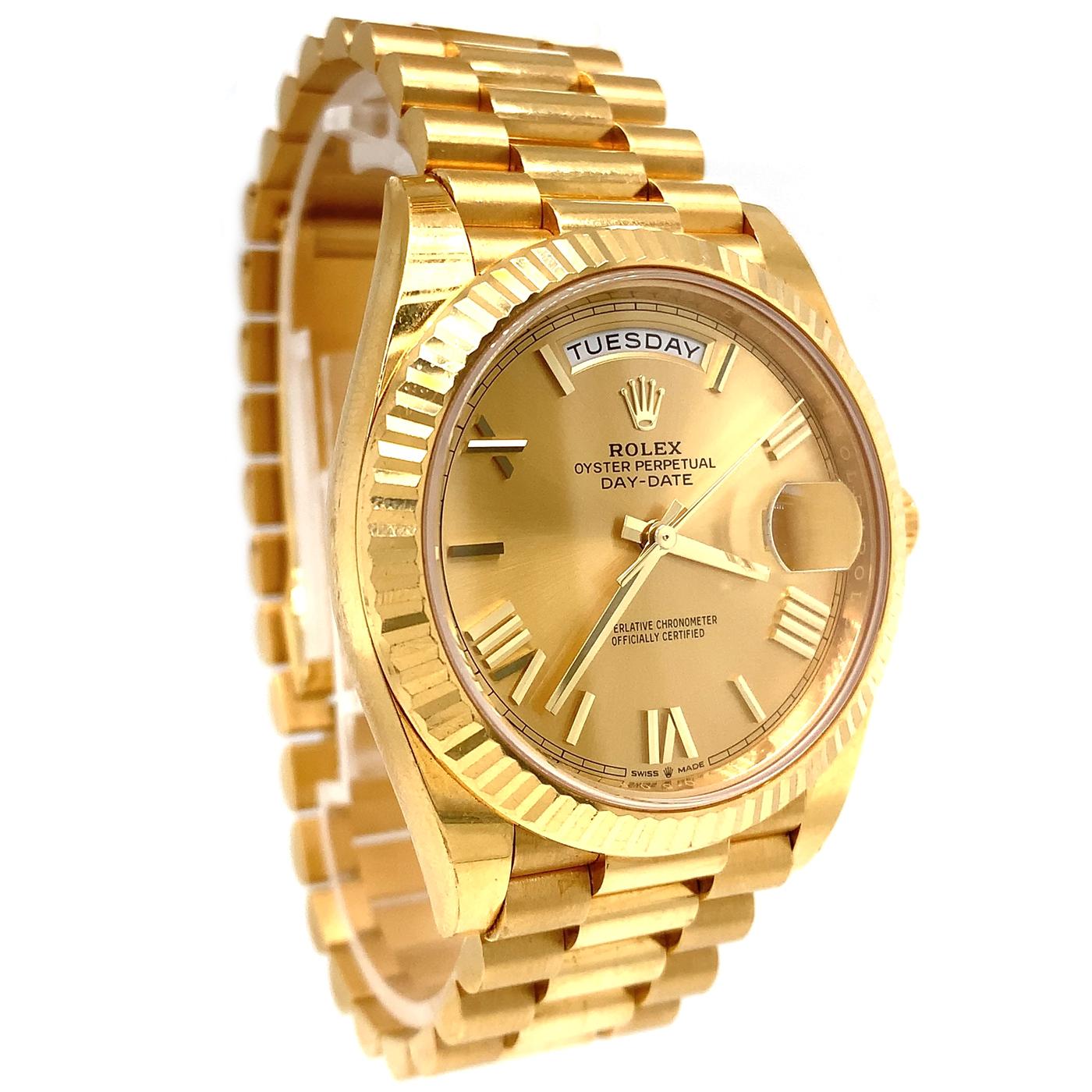 The Oyster Perpetual Day-Date 40 in 18 ct yellow gold with a champagne-color roman dial, a Fluted bezel, and a President bracelet. The Day-Date was the first watch to indicate the day of the week spelled out in full when it was first presented in