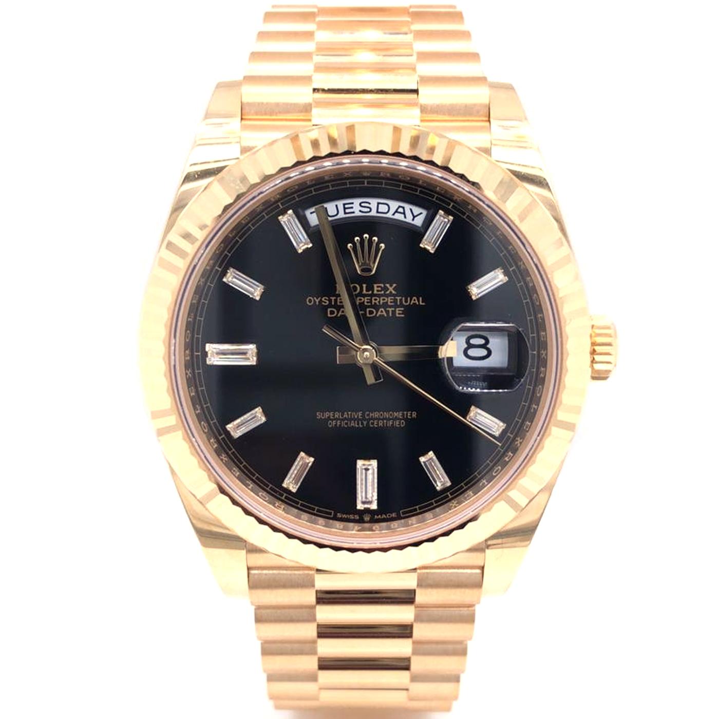 The Oyster Perpetual Day-Date 40 in 18 Ct Yellow Gold with a Bright Black, Diamond-Set Dial, Fluted Bezel, and a President Bracelet. The Day-Date was the first watch to indicate the day of the week spelled out in full when it was first presented in