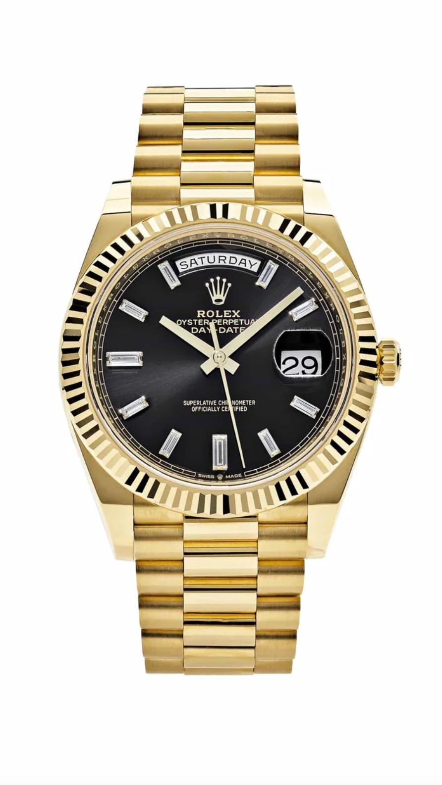 The Rolex Day-Date 40 228238 is a symbol of prestige and timeless elegance. Crafted from 18k yellow gold, its 40mm case exudes luxury and durability. The iconic fluted bezel adds classic refinement, while the striking black dial is adorned with