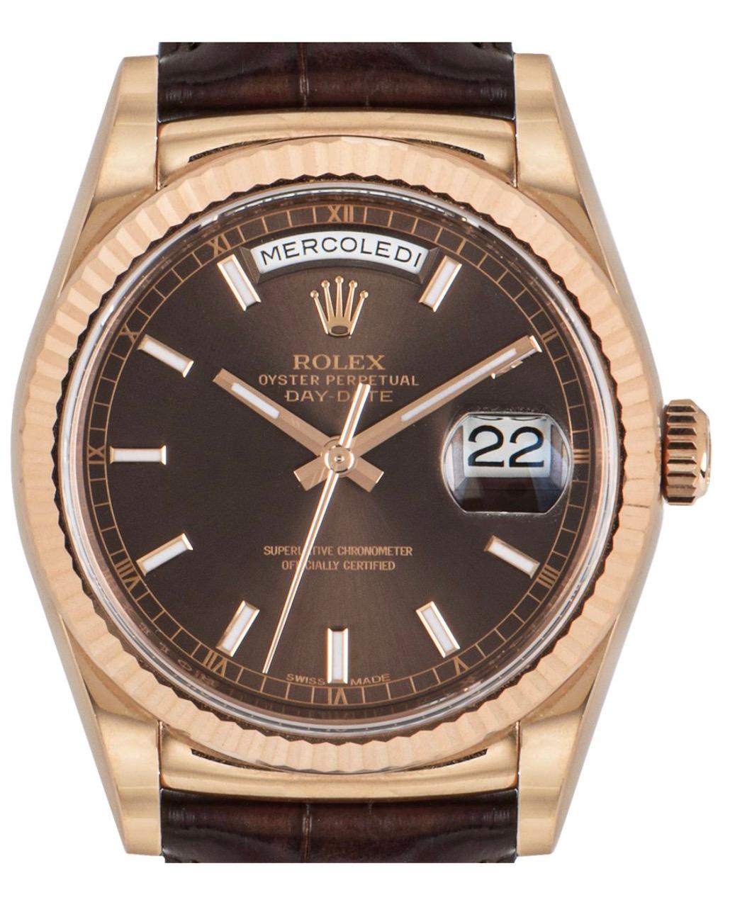 A 36mm Day-Date in rose gold, by Rolex. Featuring a distinctive chocolate dial with rose gold applied hour markers and a fixed rose gold fluted bezel. Fitted with a scratch resistant sapphire crystal and self-winding automatic movement. The watch is