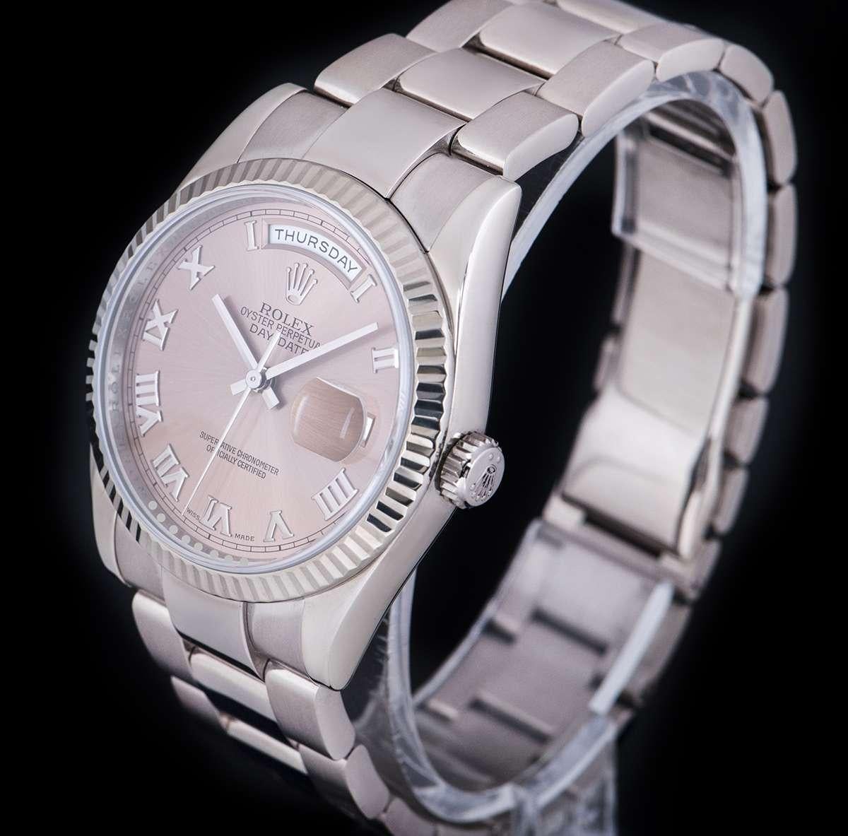 An 18k White Gold Oyster Perpetual Day-Date Gents Wristwatch, salmon dial with applied roman numerals, day at 12 0'clock, date at 3 0'clock, a fixed 18k white gold fluted bezel, an 18k white gold oyster bracelet with a concealed 18k white gold