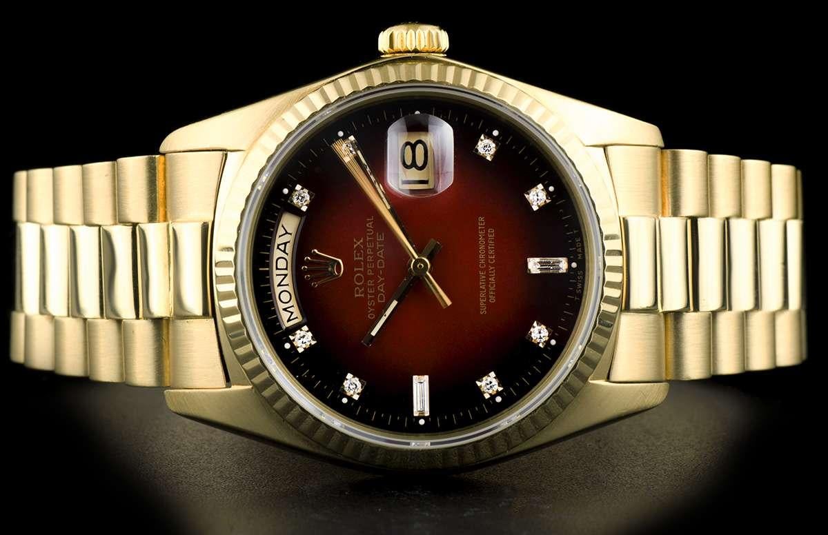 An 18k Yellow Gold Oyster Perpetual Day-Date Gents Wristwatch, maroon vignette dial set with 8 applied round brilliant cut diamond hour markers and 2 baguette cut diamond hour markers, day aperture at 12 0'clock, date aperture at 3 0'clock, a fixed