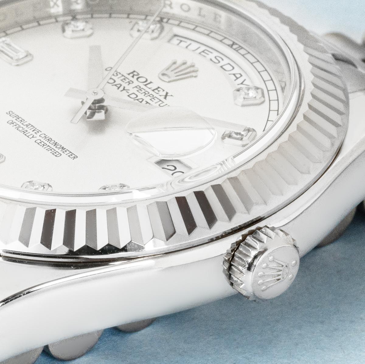 A white gold Rolex Day-Date II, reference 218239, with a 41mm case. It features a silver dial set with 2 baguette and 8 round brilliant-cut diamond hour markers. The watch includes a fluted bezel, President bracelet, and concealed Crownclasp,