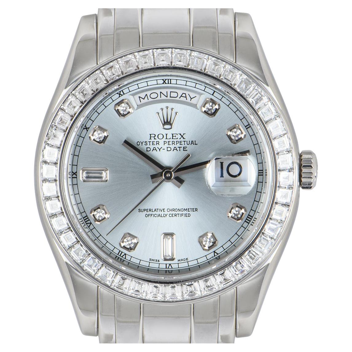 A men's Day-Date Masterpiece, in platinum by Rolex. Featuring a distinctive ice blue dial set with 8 single cut diamonds and 2 baguette diamond hour markers. Complementing the dial is a platinum bezel set with 42 tapered baguette diamonds.

Powered