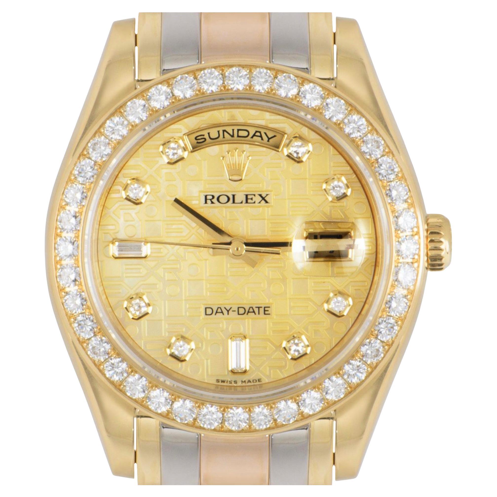 A stunning Day-Date Masterpiece crafted in tri-gold by Rolex. Features a mother of pearl jubilee dial with 8 single cut diamonds and 2 baguette cut diamond hour markers. Complementing the dial is a yellow gold bezel set with 40 round brilliant cut