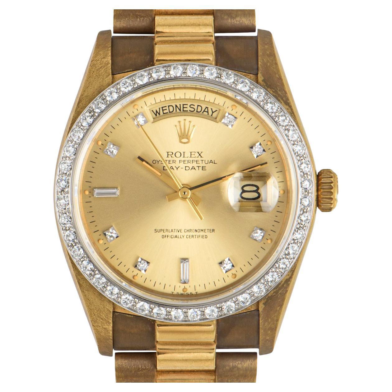 A stunning vintage 36mm Day-Date by Rolex crafted in yellow gold. Featuring a champagne dial with 8 round brilliant cut diamonds and 2 baguette cut diamond hour markers, as well as a yellow gold fixed bezel set with 44 round brilliant cut